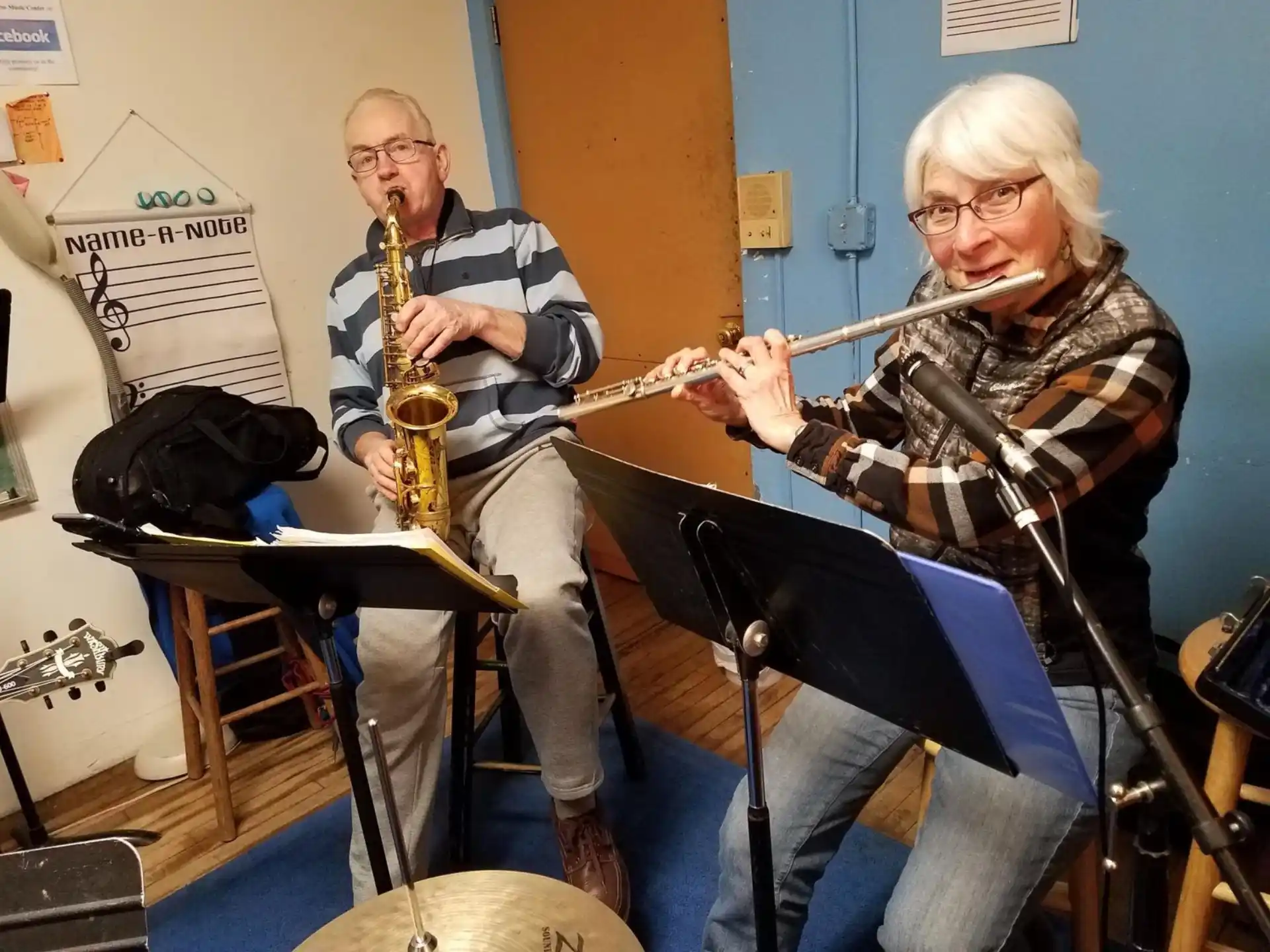 a man and woman playing instruments