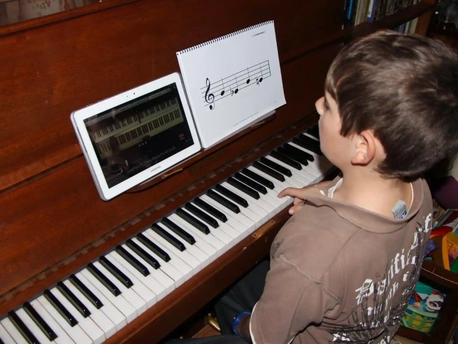a boy playing a piano