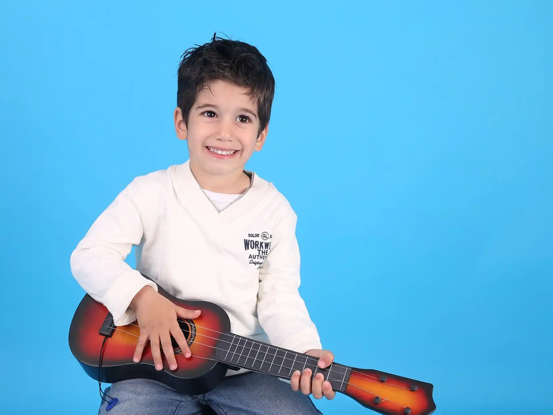 a boy holding a guitar