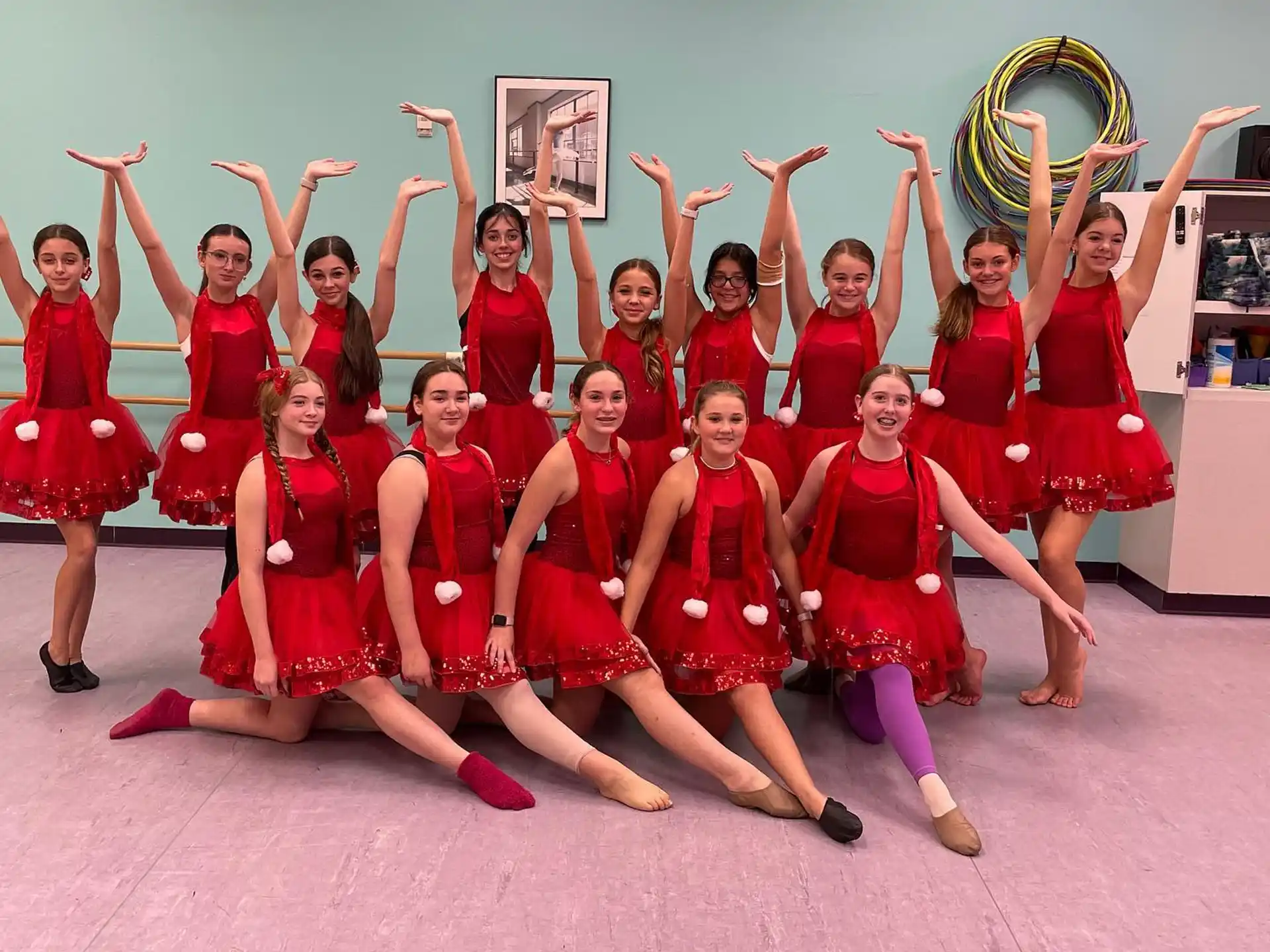 a group of women in red dresses