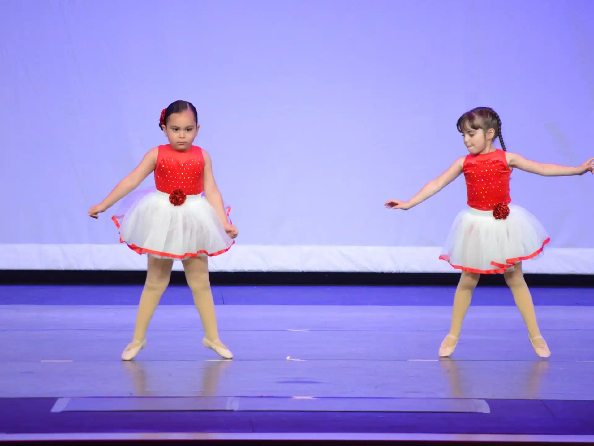 two girls wearing dresses and dancing