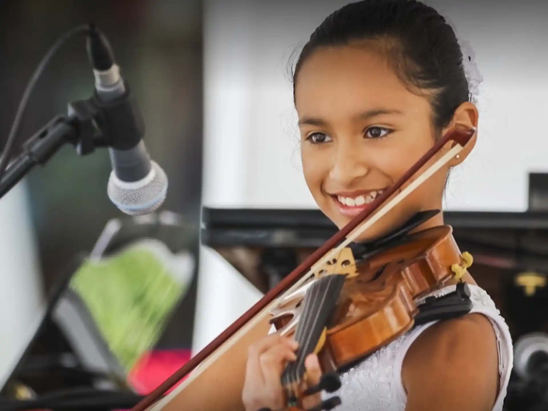 a young boy playing a violin