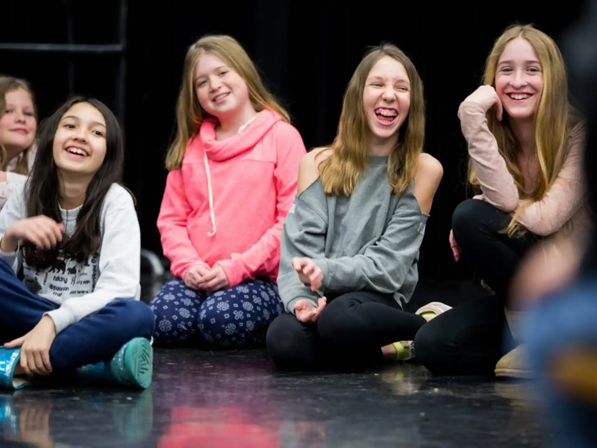 a group of girls sitting on the floor