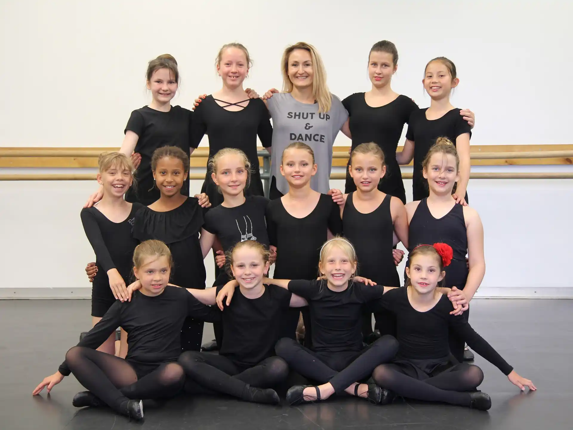 a group of women in black shirts