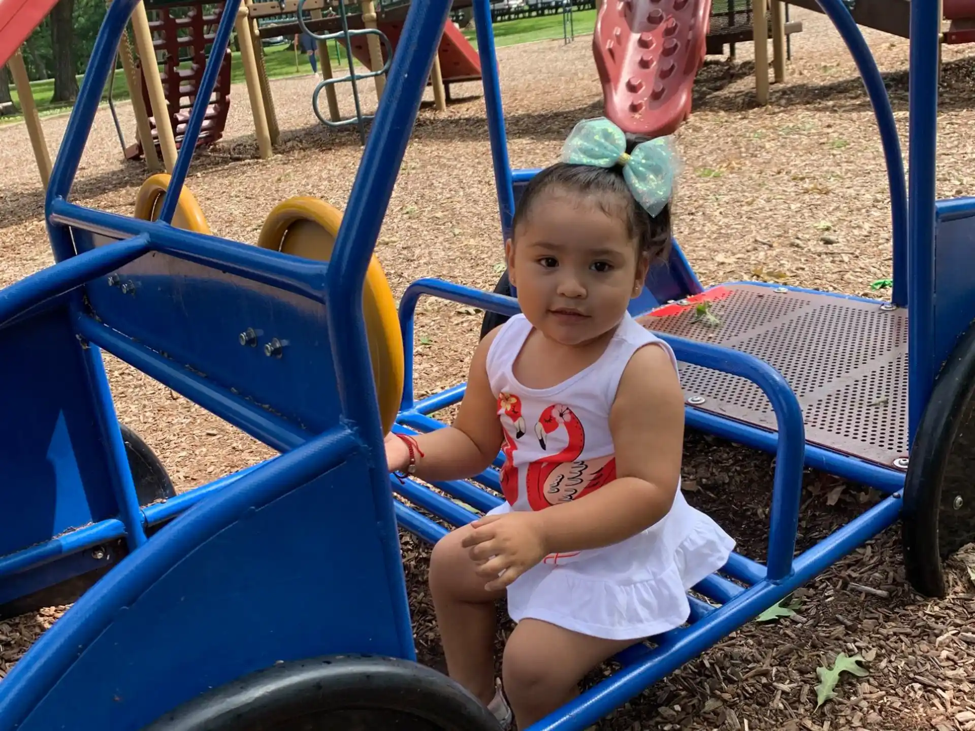 a child sitting in a playground toy