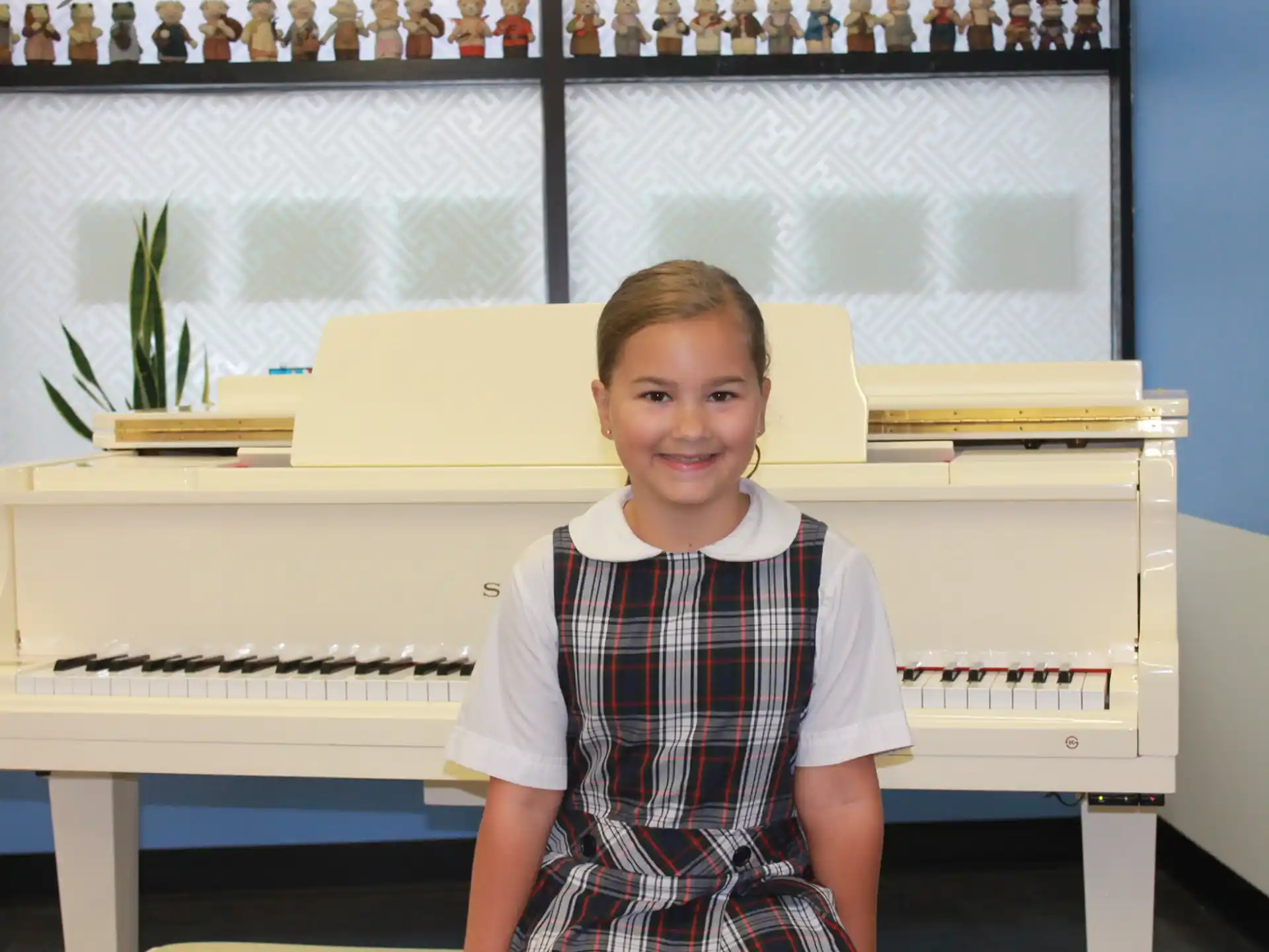 a boy standing in front of a piano