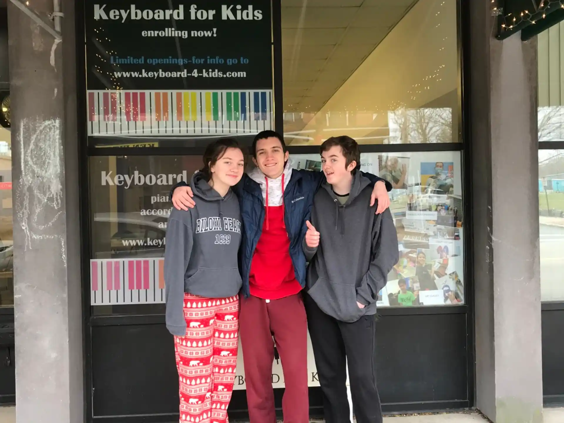 a group of people posing for a photo in front of a store