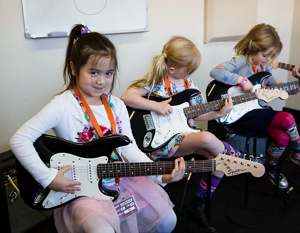 a group of girls playing guitars