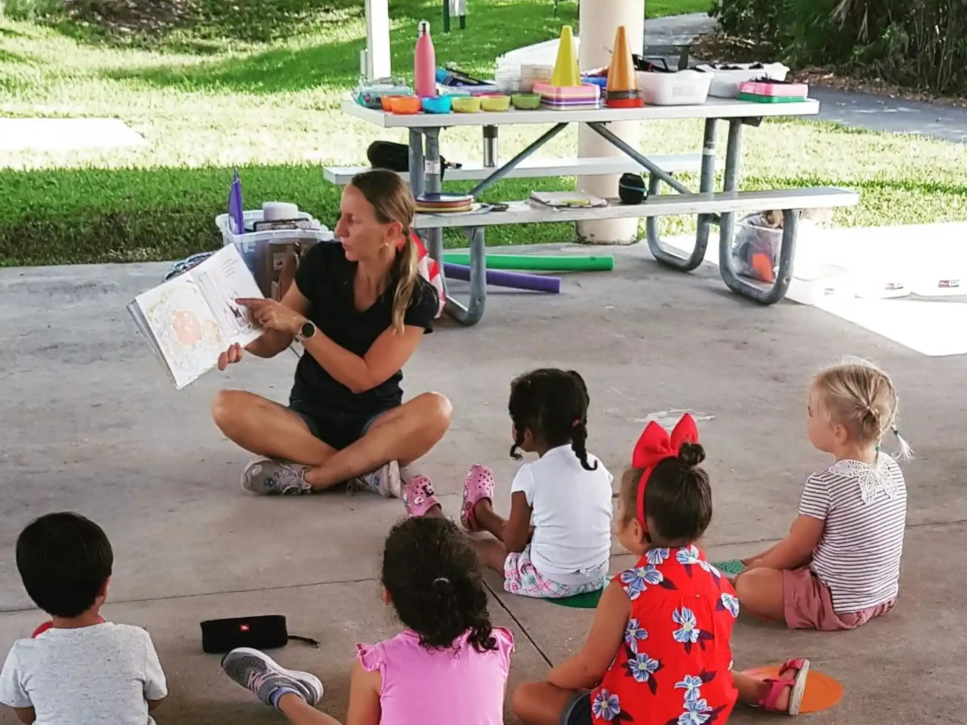 a person reading to a group of children