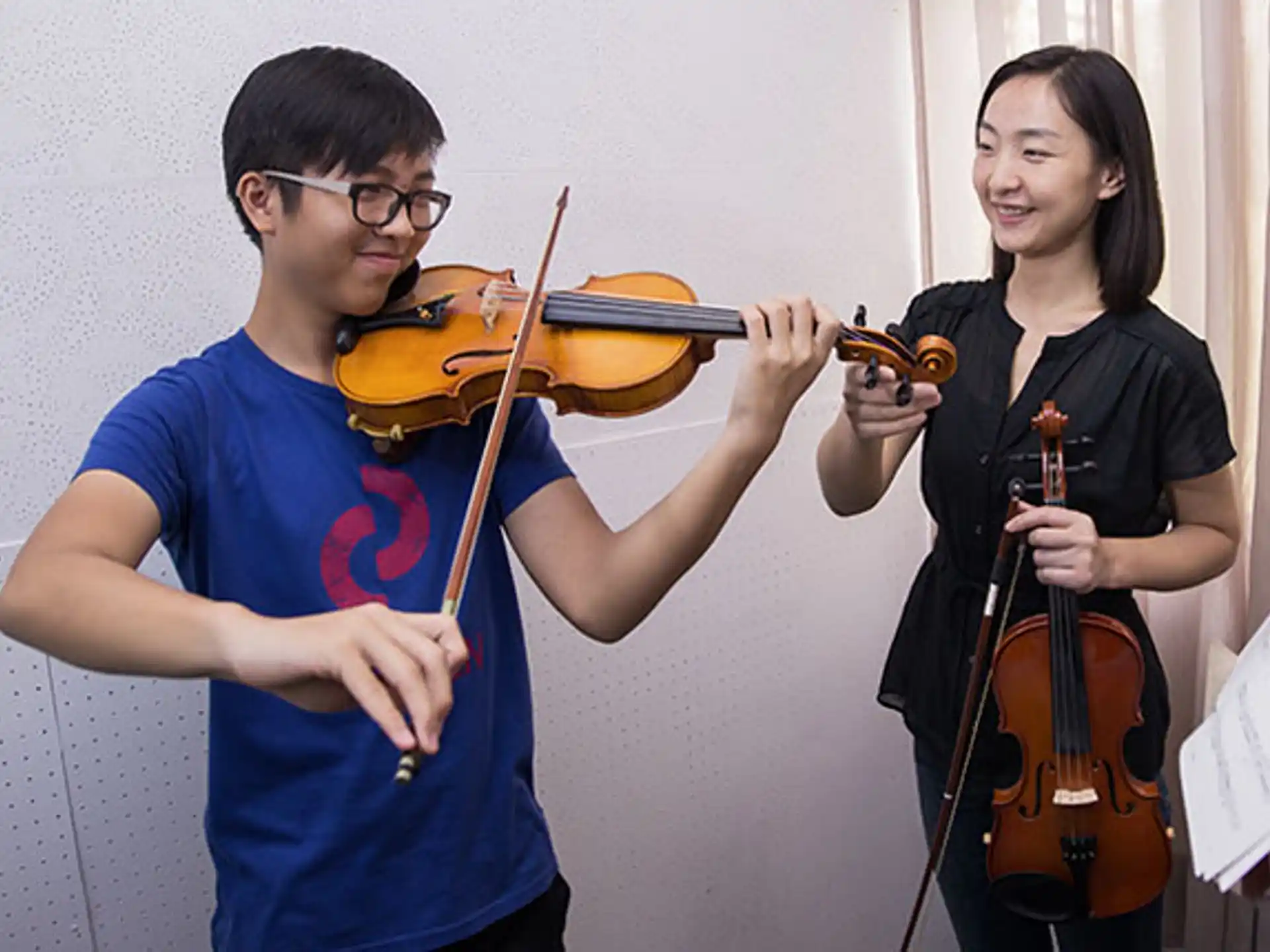 a man and a woman playing violin
