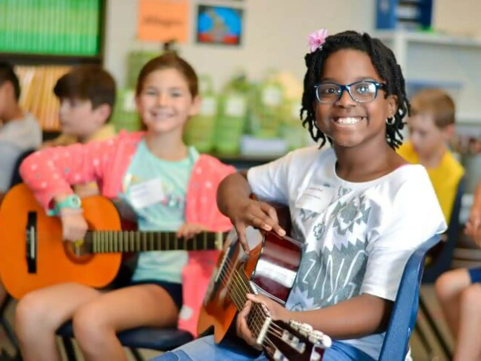 a group of kids playing guitars