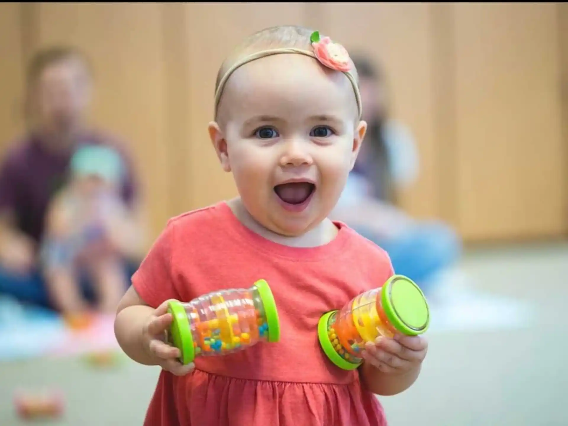 a baby holding toys
