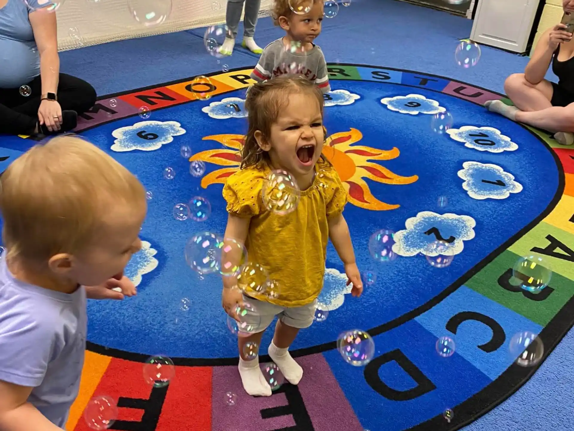 a group of children playing on a mat