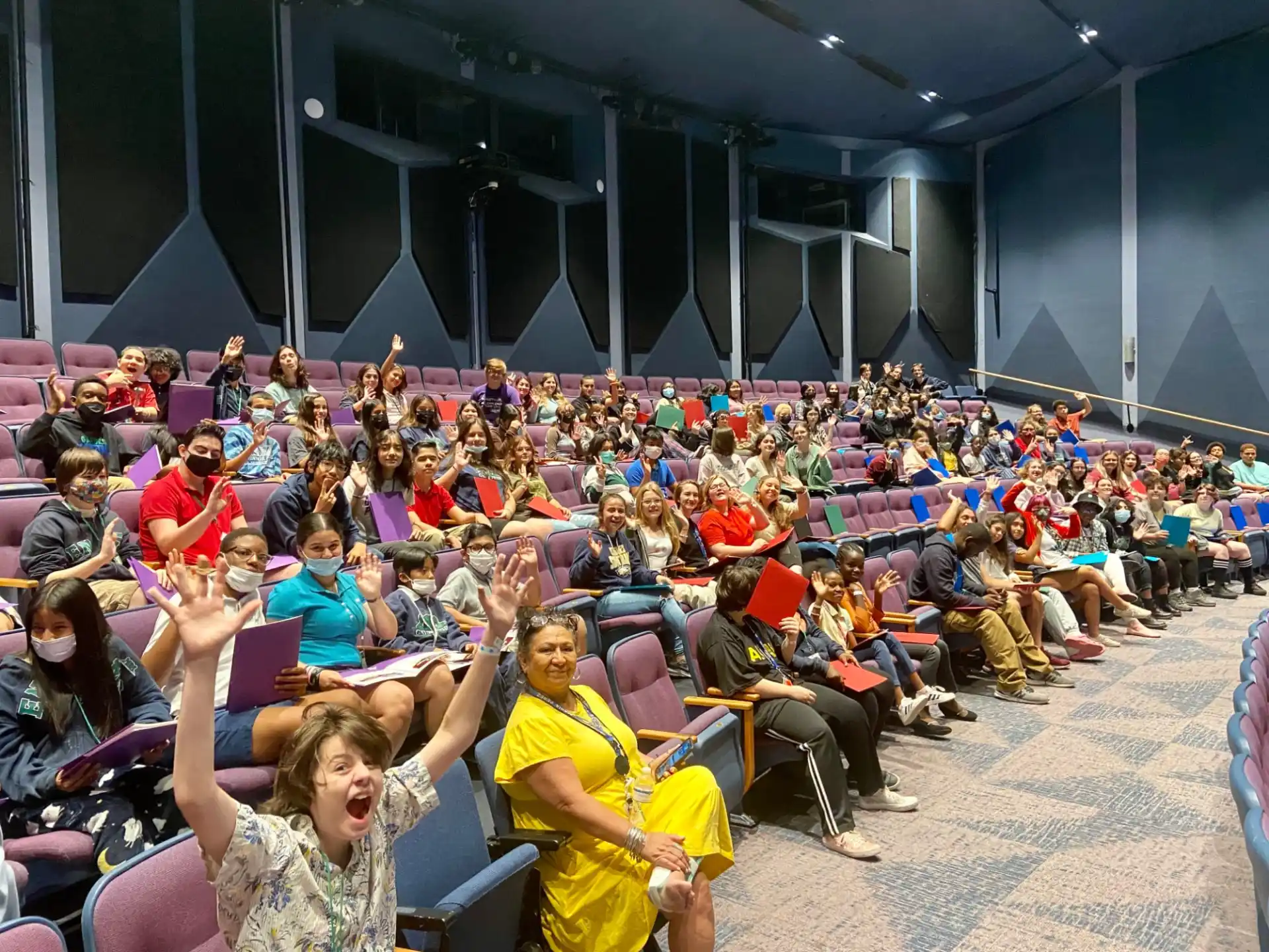 a large group of people sitting in chairs