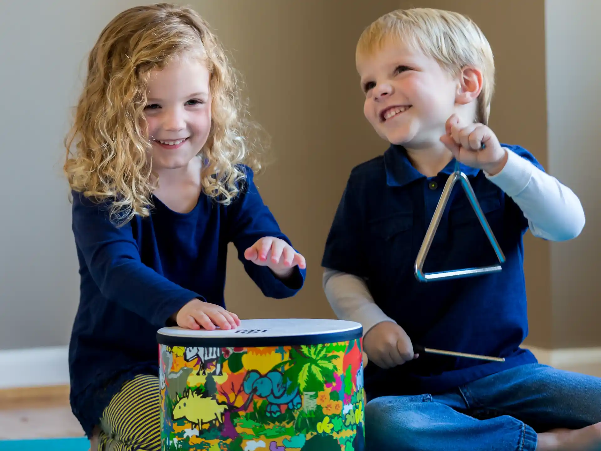 a boy and girl holding a gift box