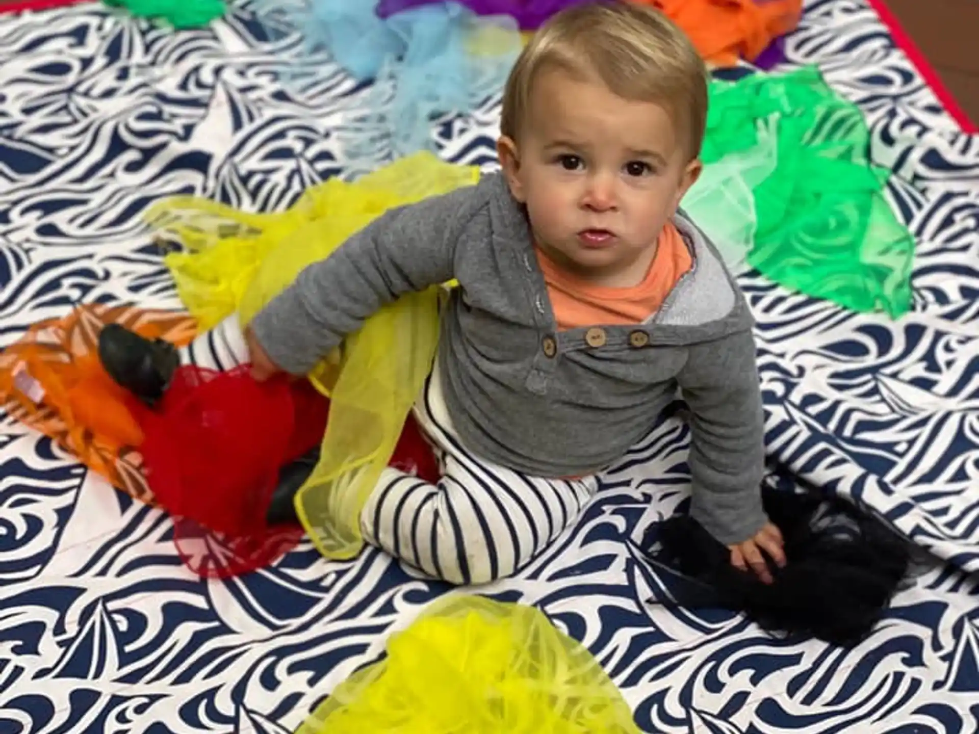 a baby lying on a blanket