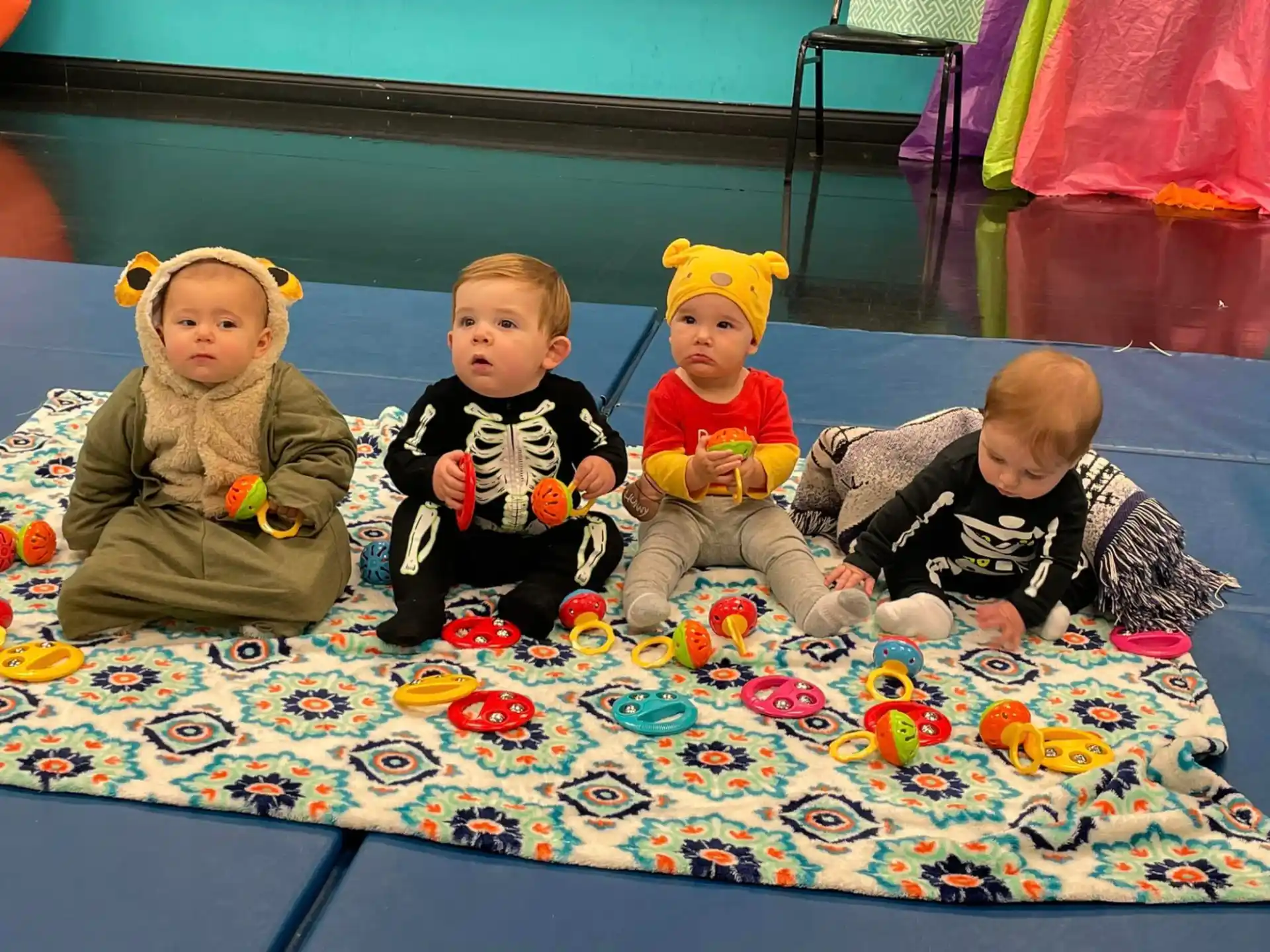 a group of children sitting on a rug