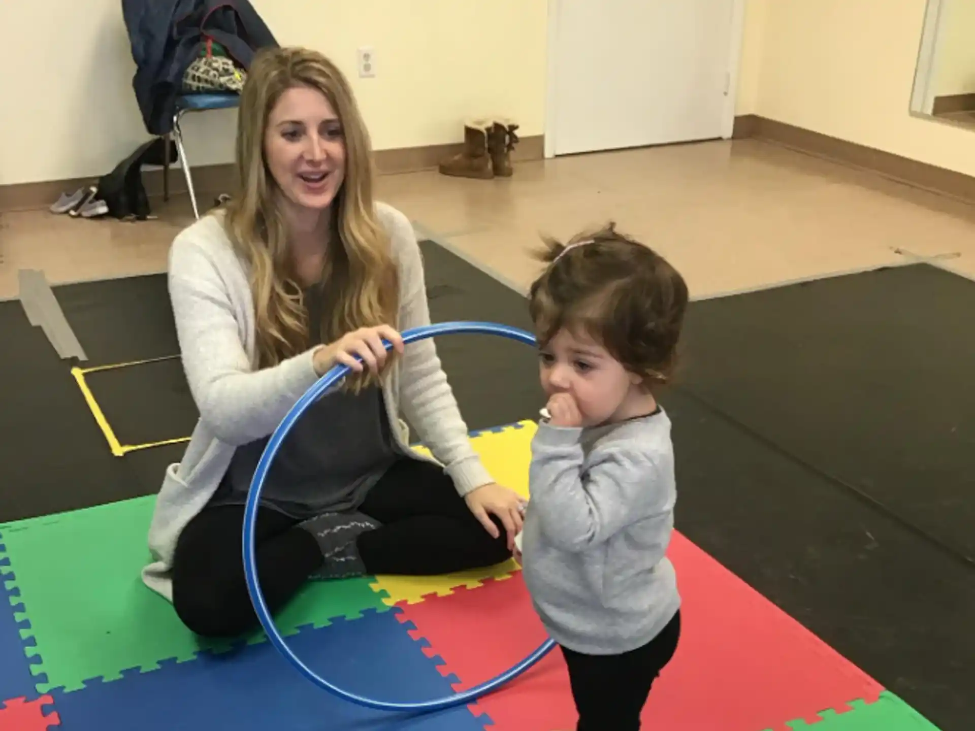 a person and a child playing with a toy