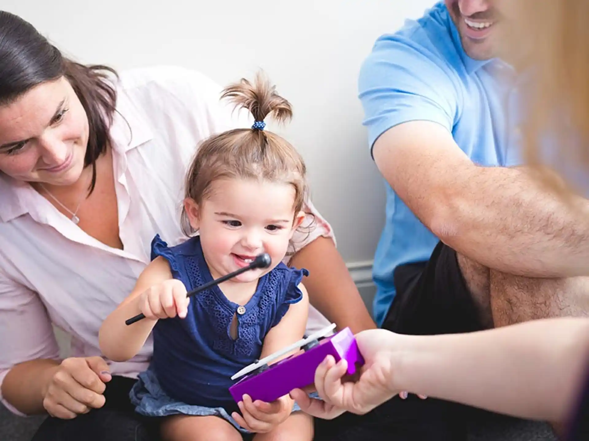 a group of people looking at a child's toy