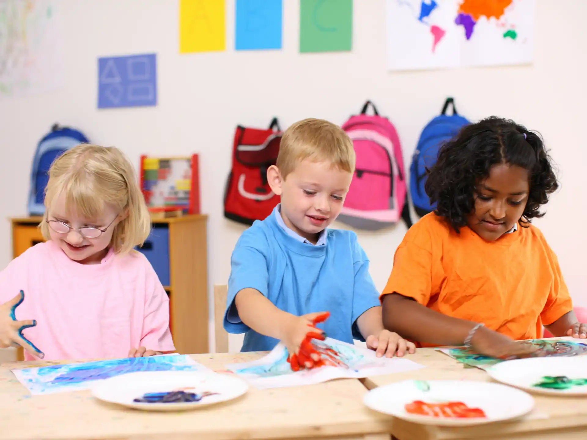 a group of children sitting at a table
