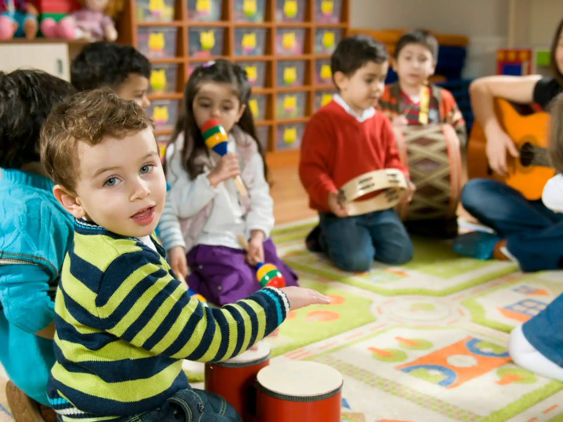 a group of children sitting around a table