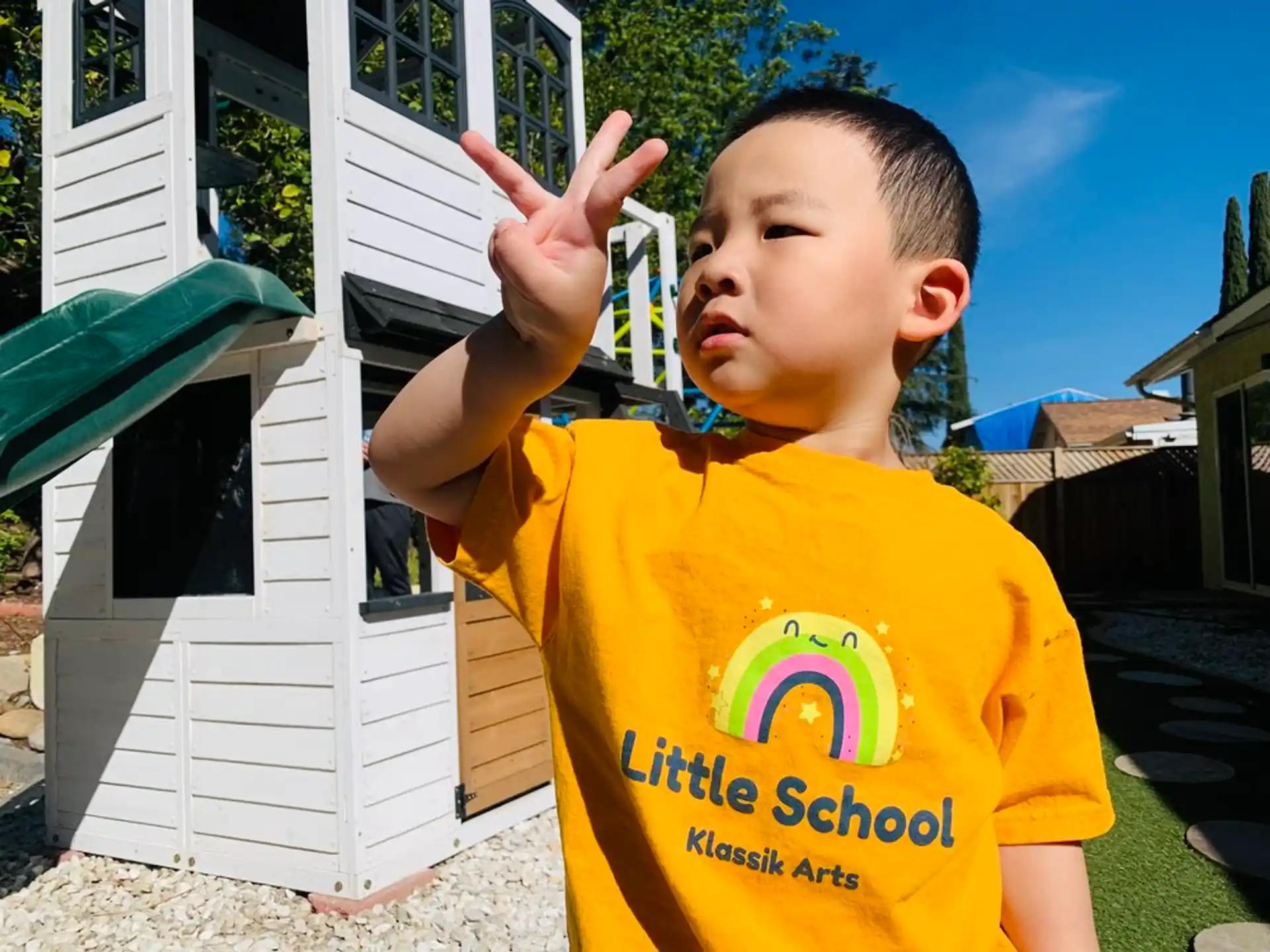 a boy in a yellow shirt