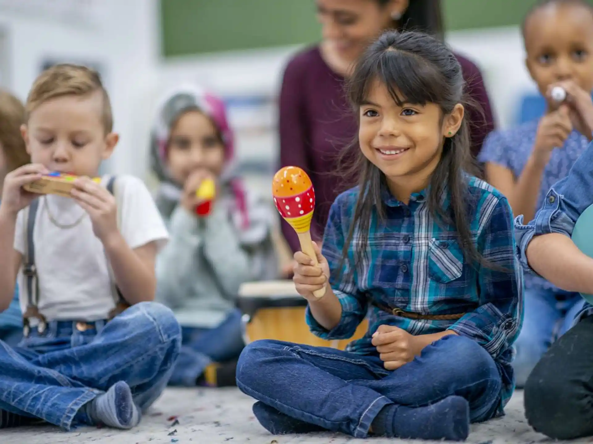 a group of children sitting on the floor eating food