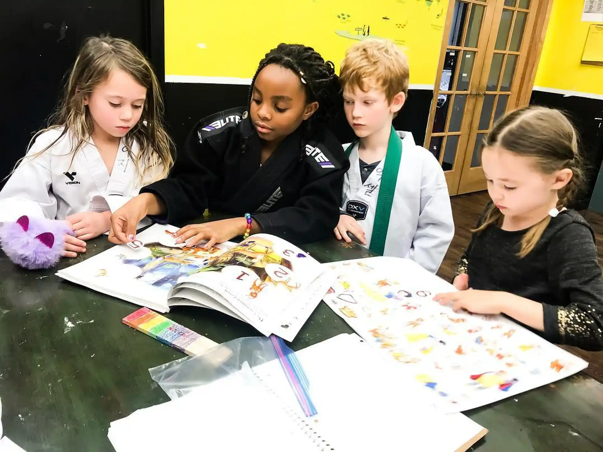 a group of children looking at a book