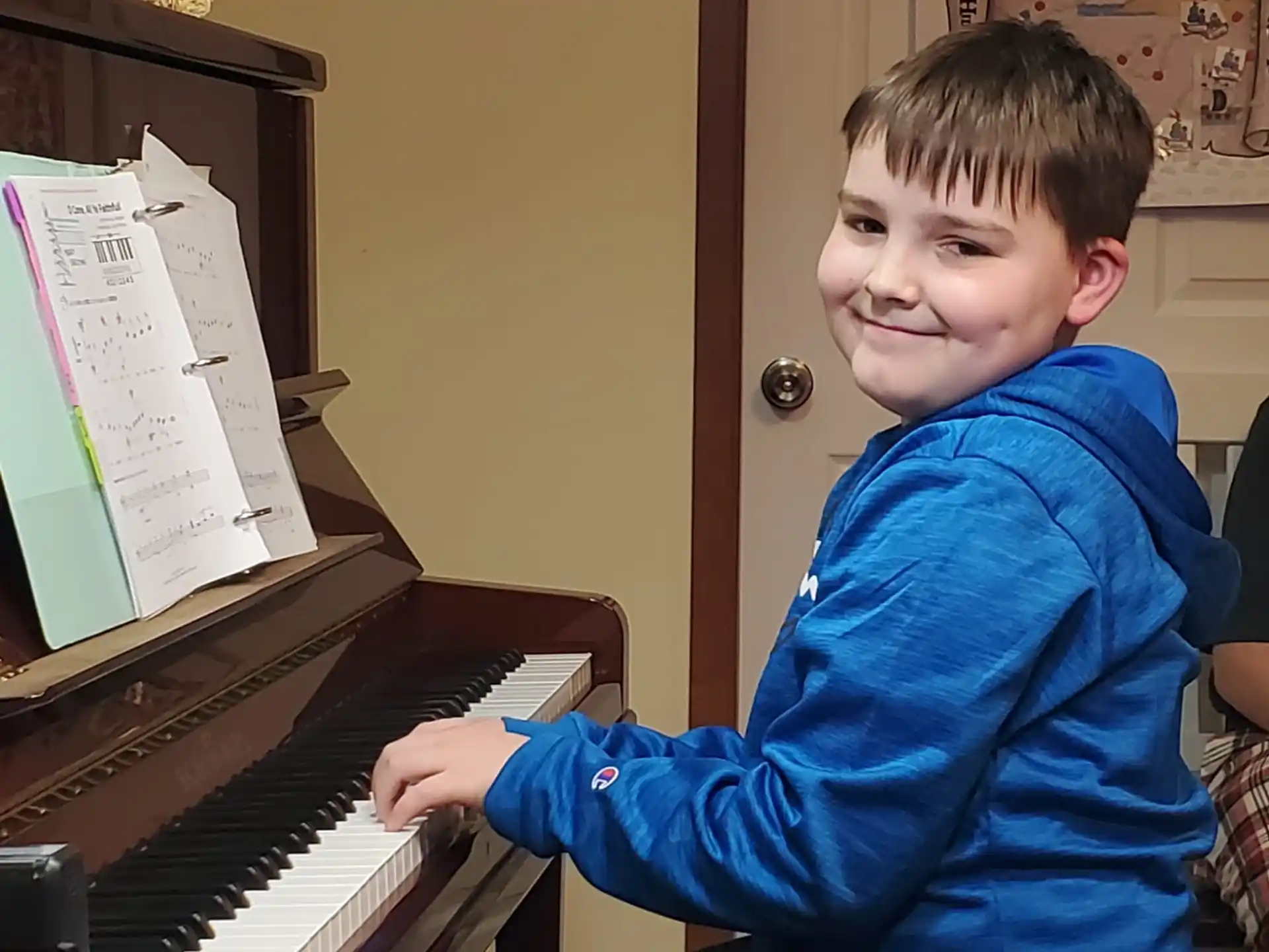 a boy playing a piano