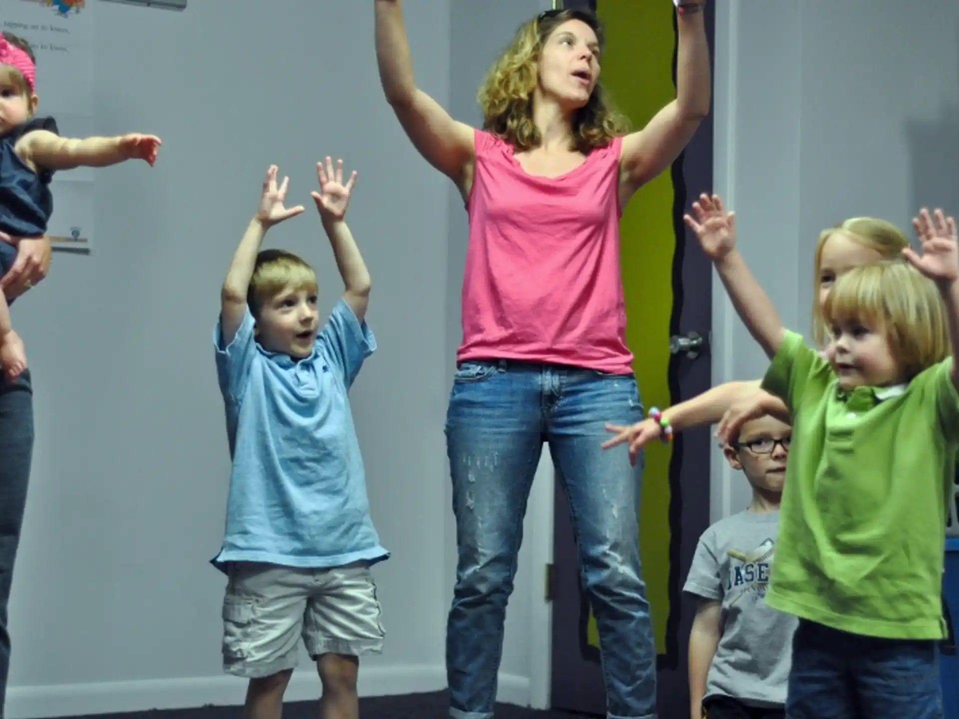 a group of children raising their hands