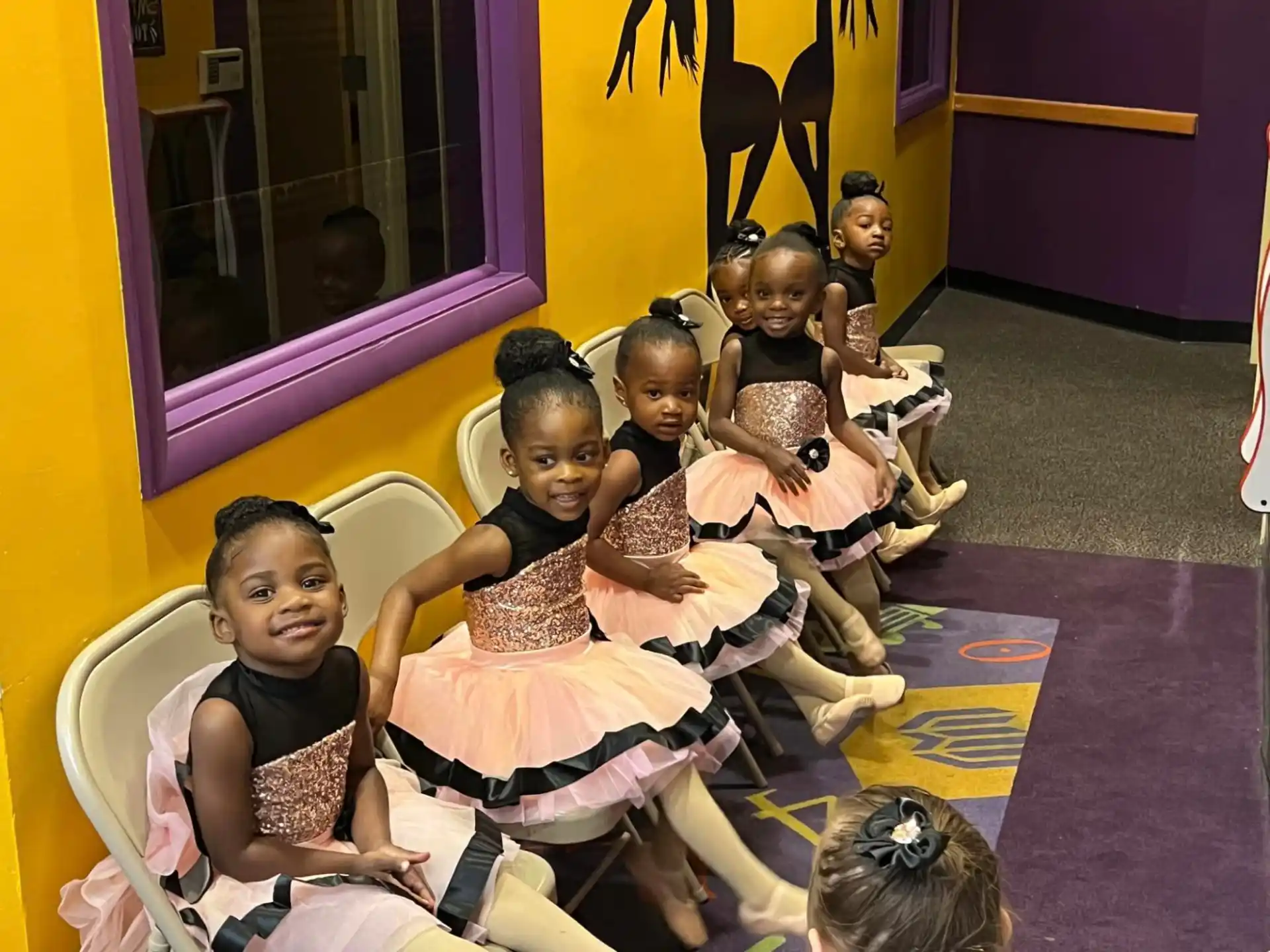 a group of children sitting in chairs