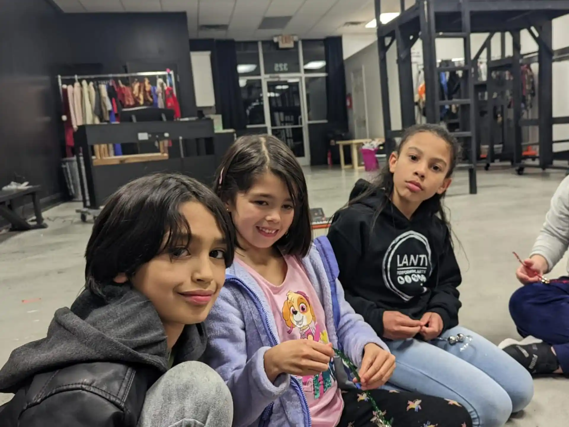 a group of people sitting on the floor posing for the camera
