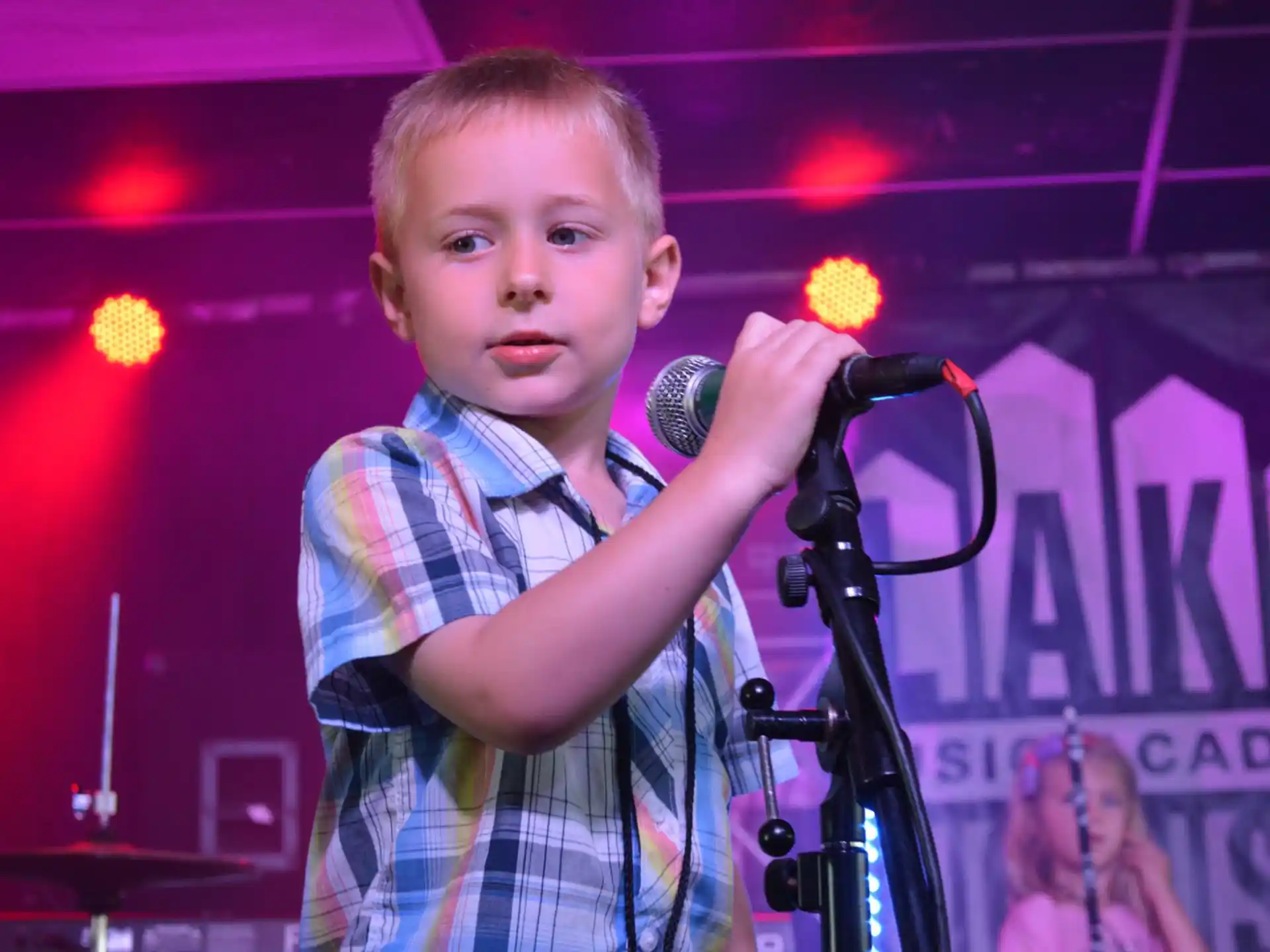 a boy holding a microphone