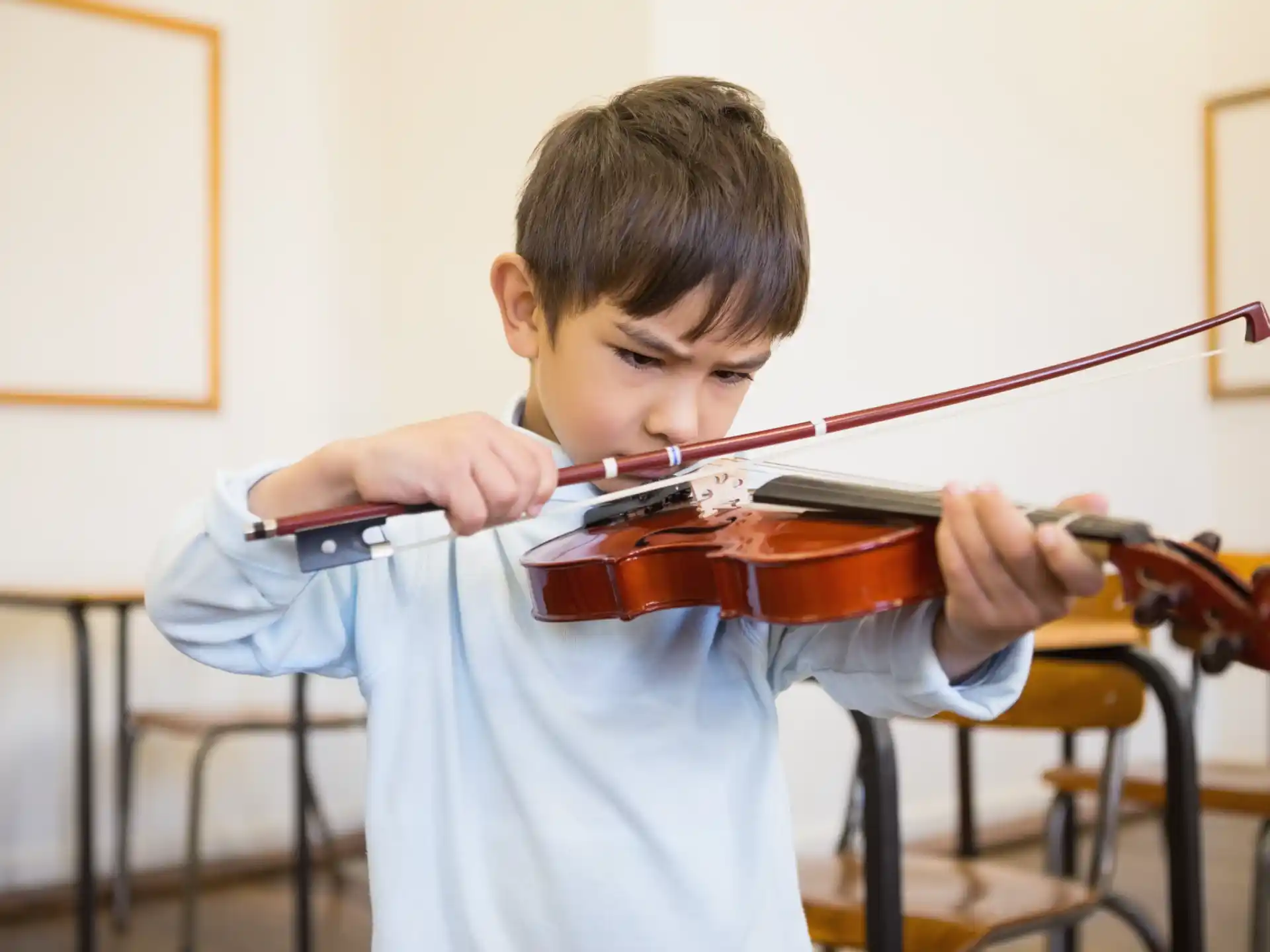 a boy playing a violin