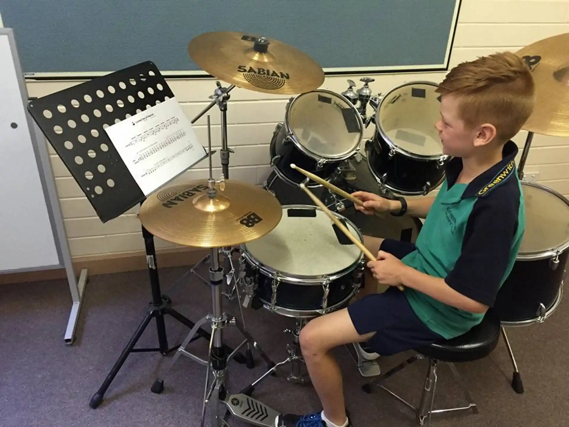 a boy playing the drums