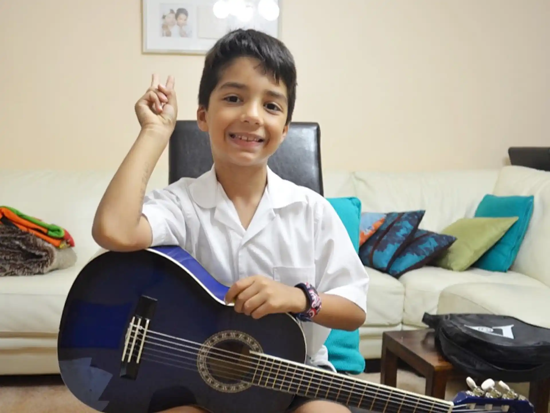 a boy holding a guitar