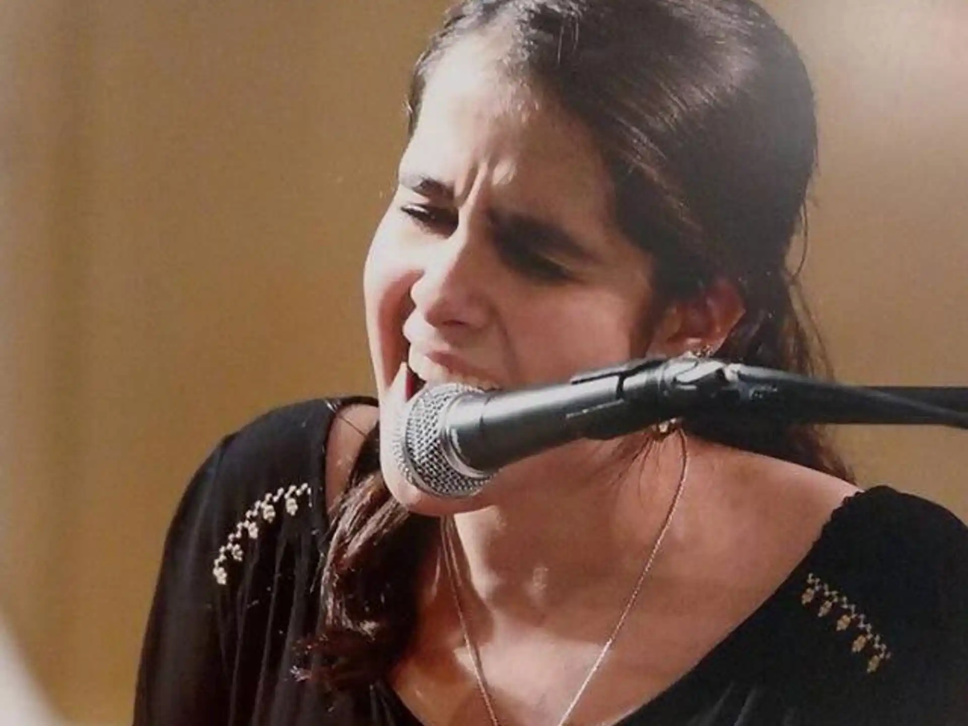 a woman singing into a microphone