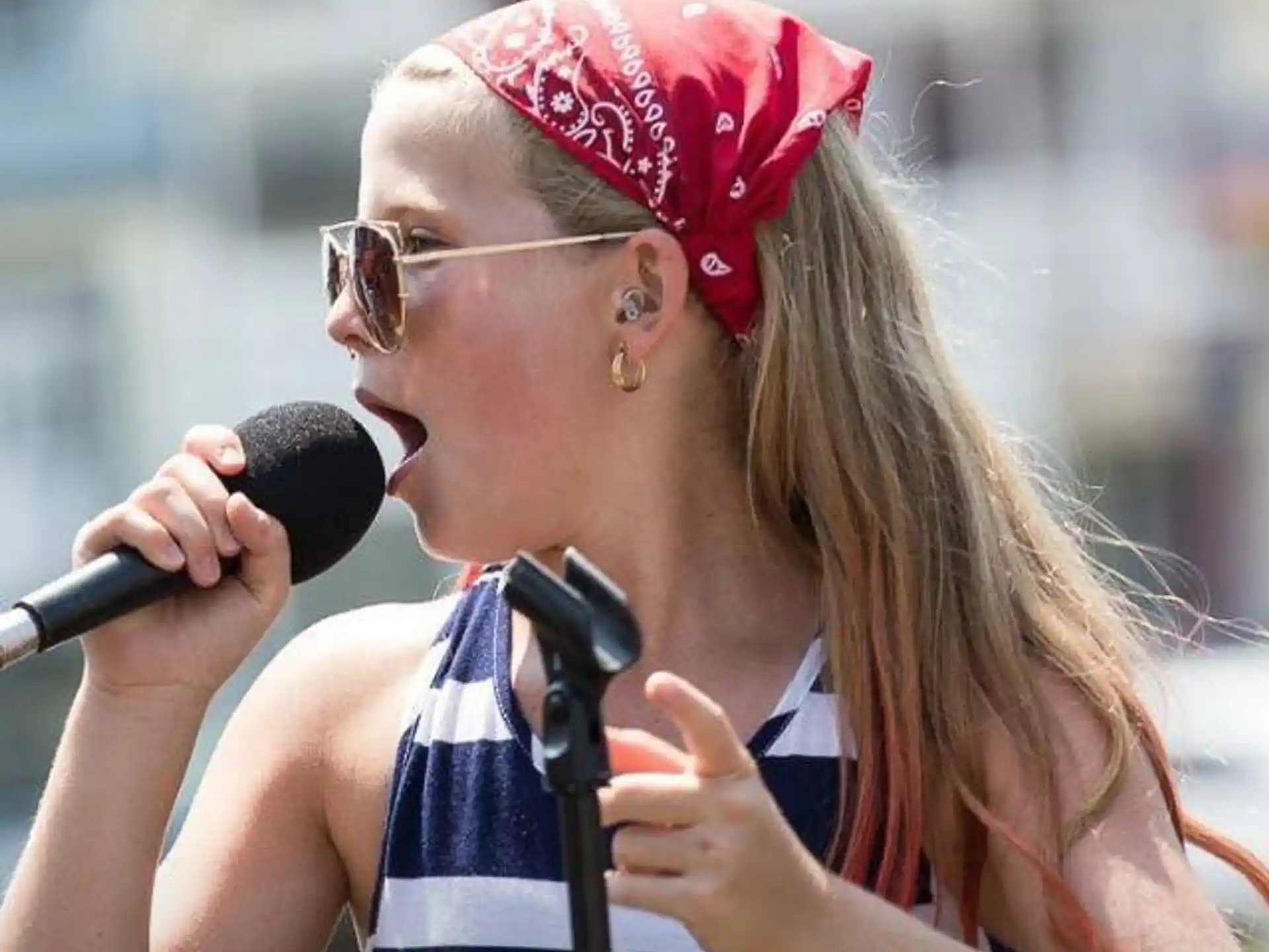 a woman singing into a microphone