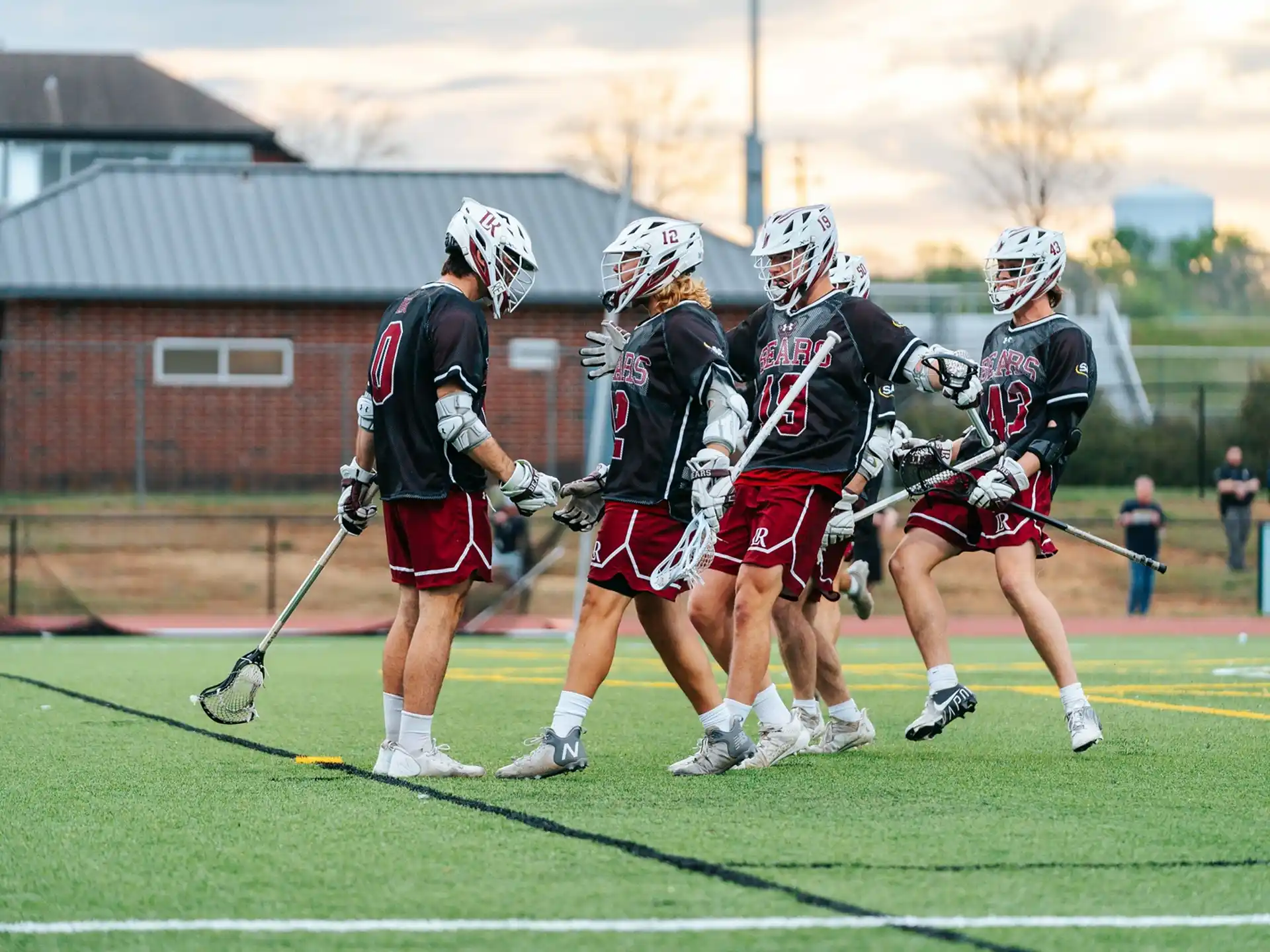 a group of people playing lacrosse