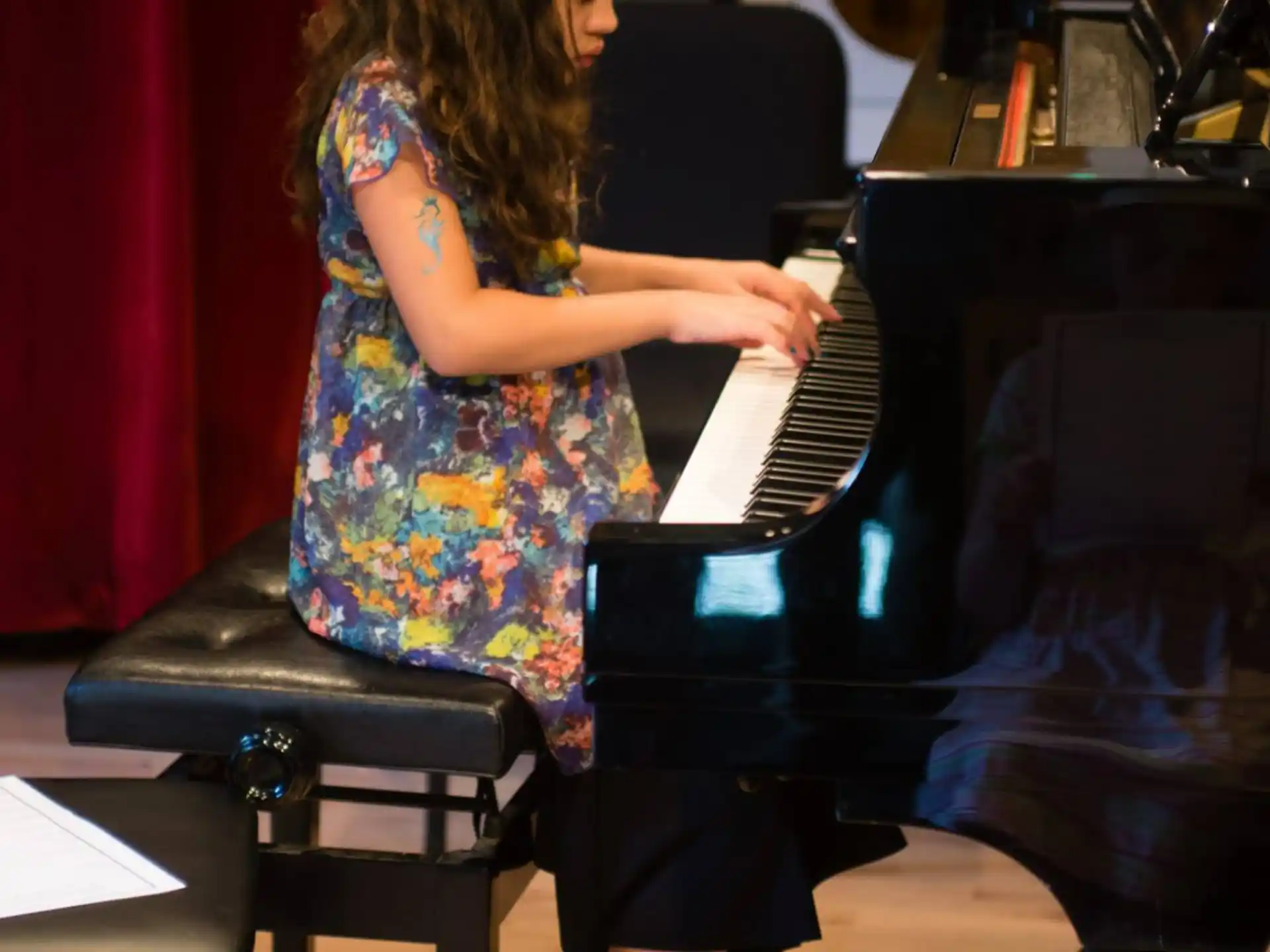 a girl playing a piano