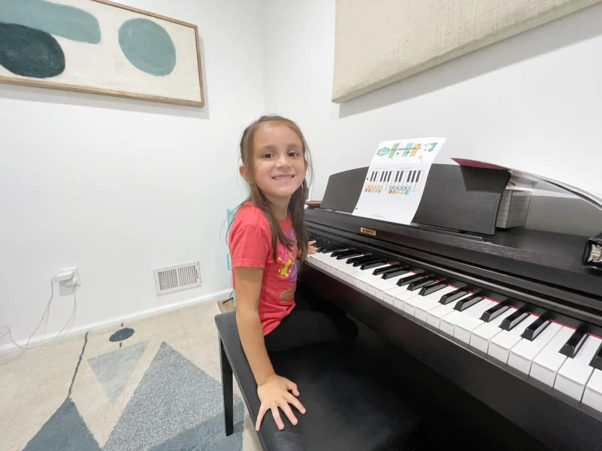 a girl sitting at a piano