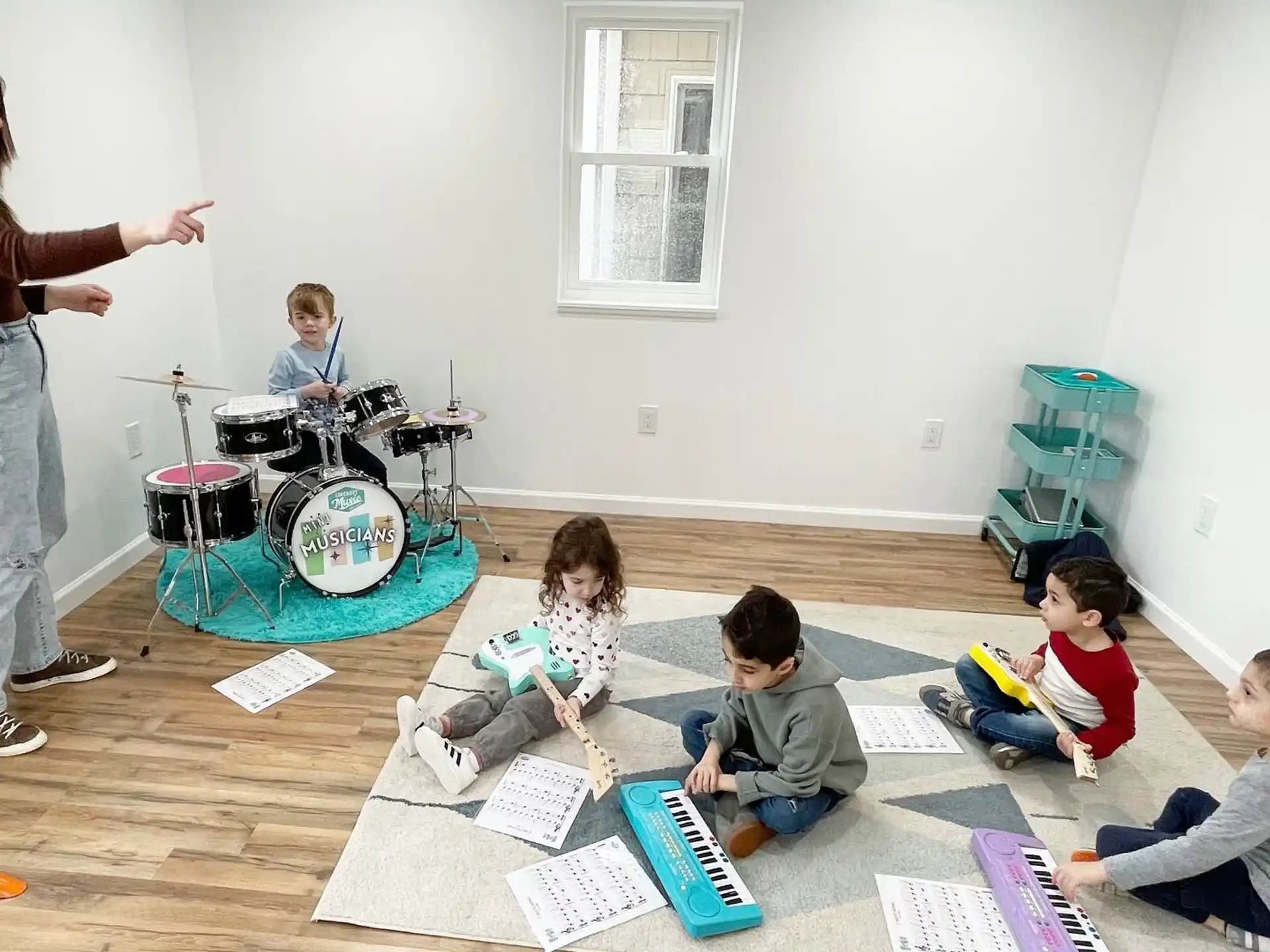 a group of children sitting on the floor in a room