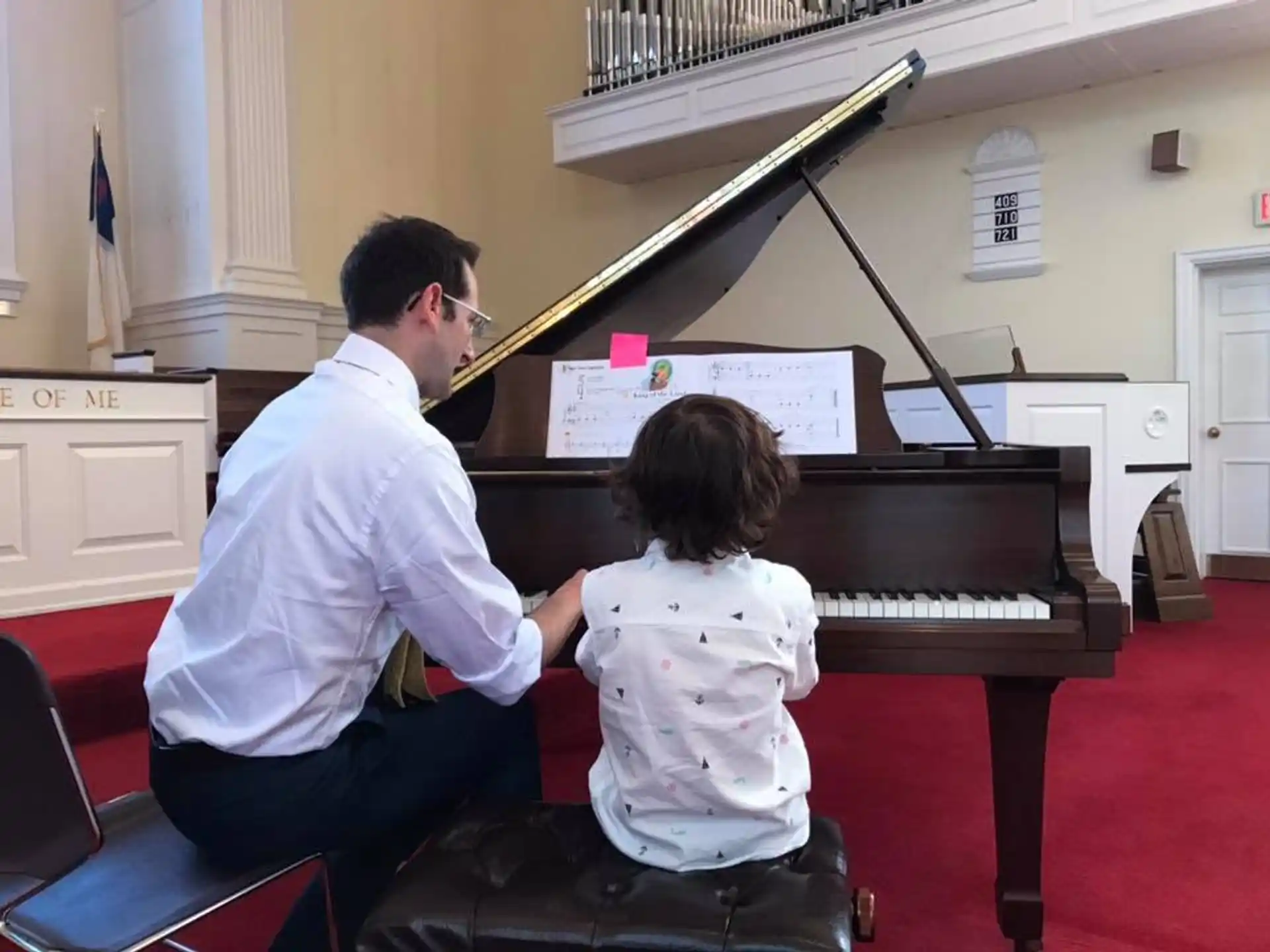 a person and a child playing piano