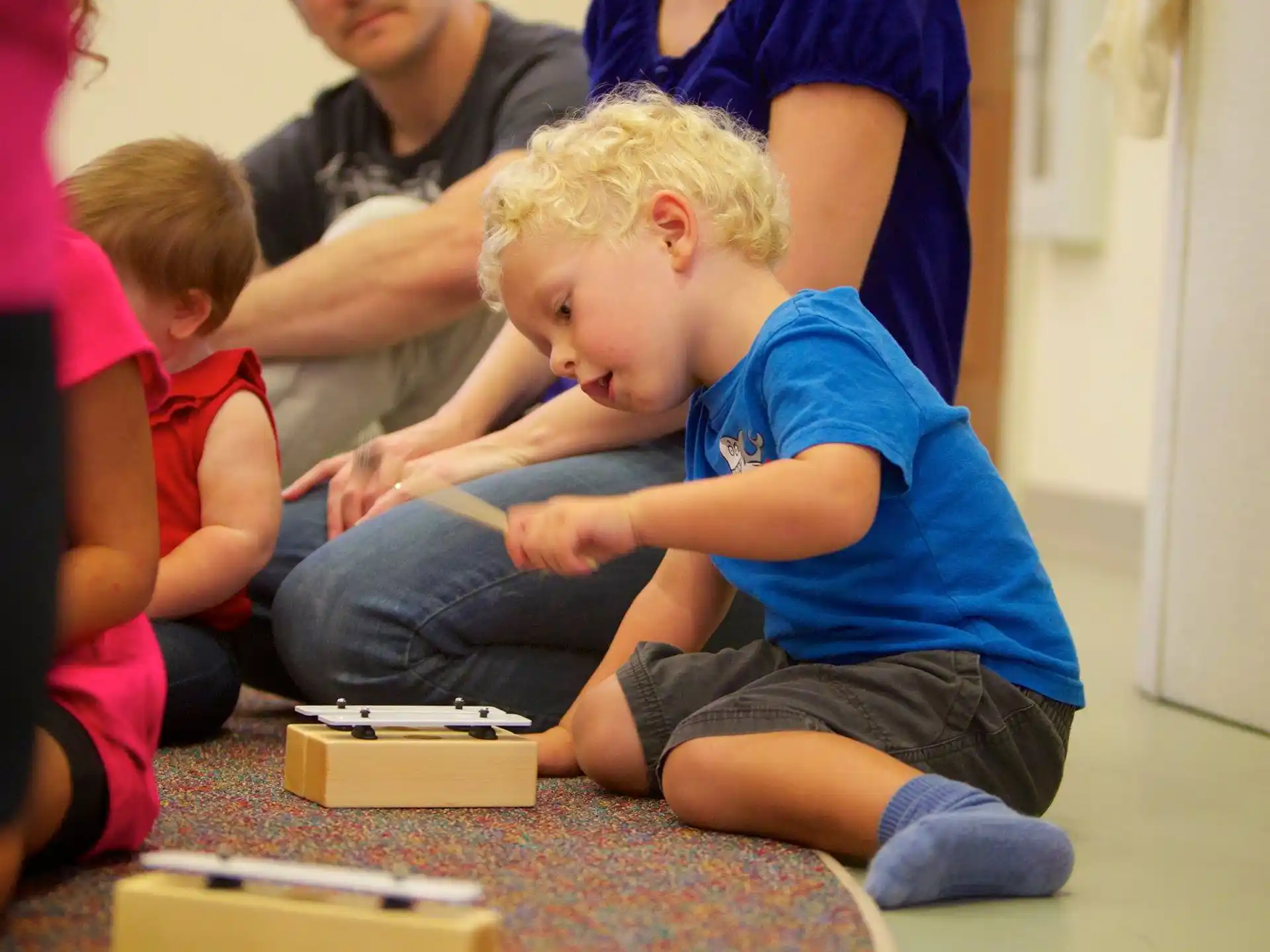 a young boy sitting on the floor