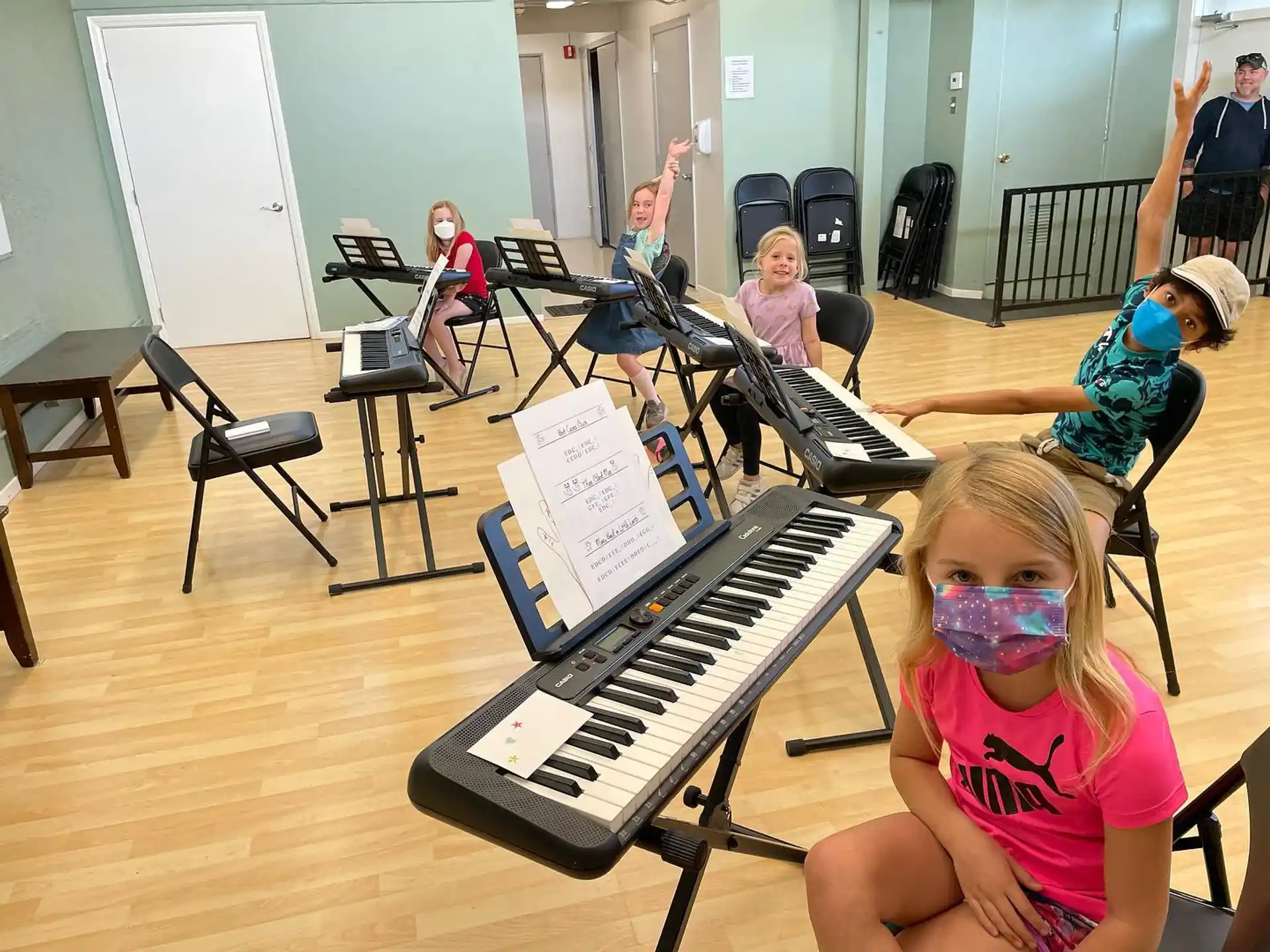 a group of children playing piano