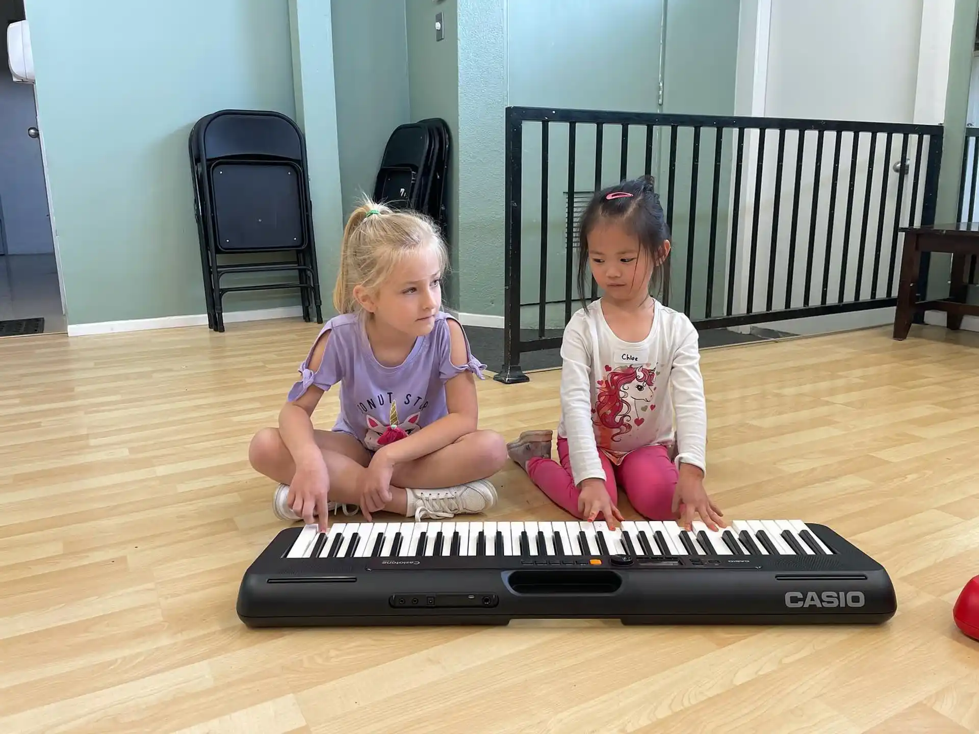 two girls sitting on the floor