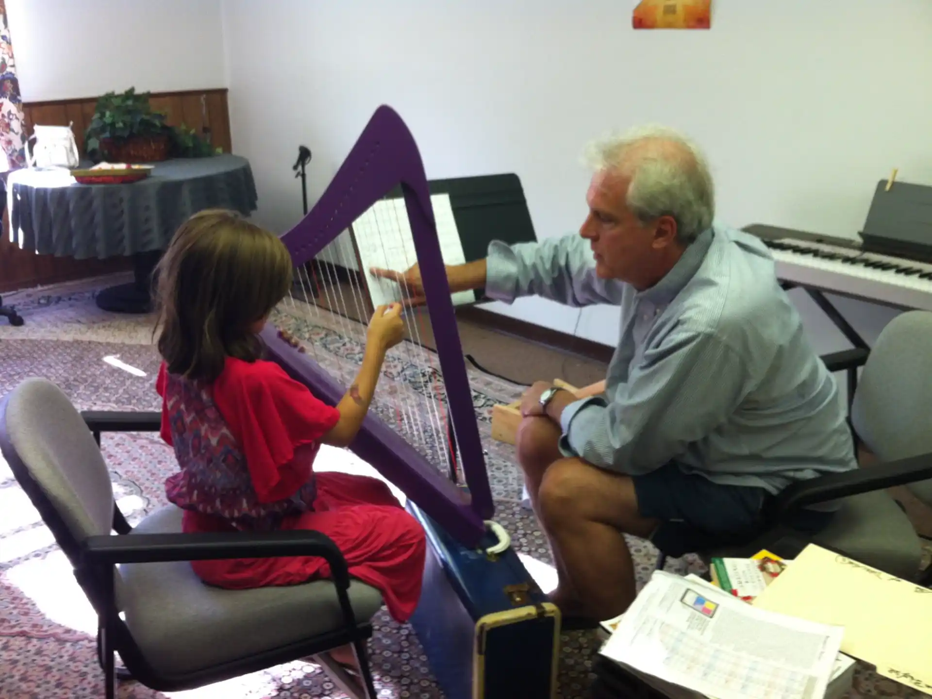 a man and a child playing a musical instrument