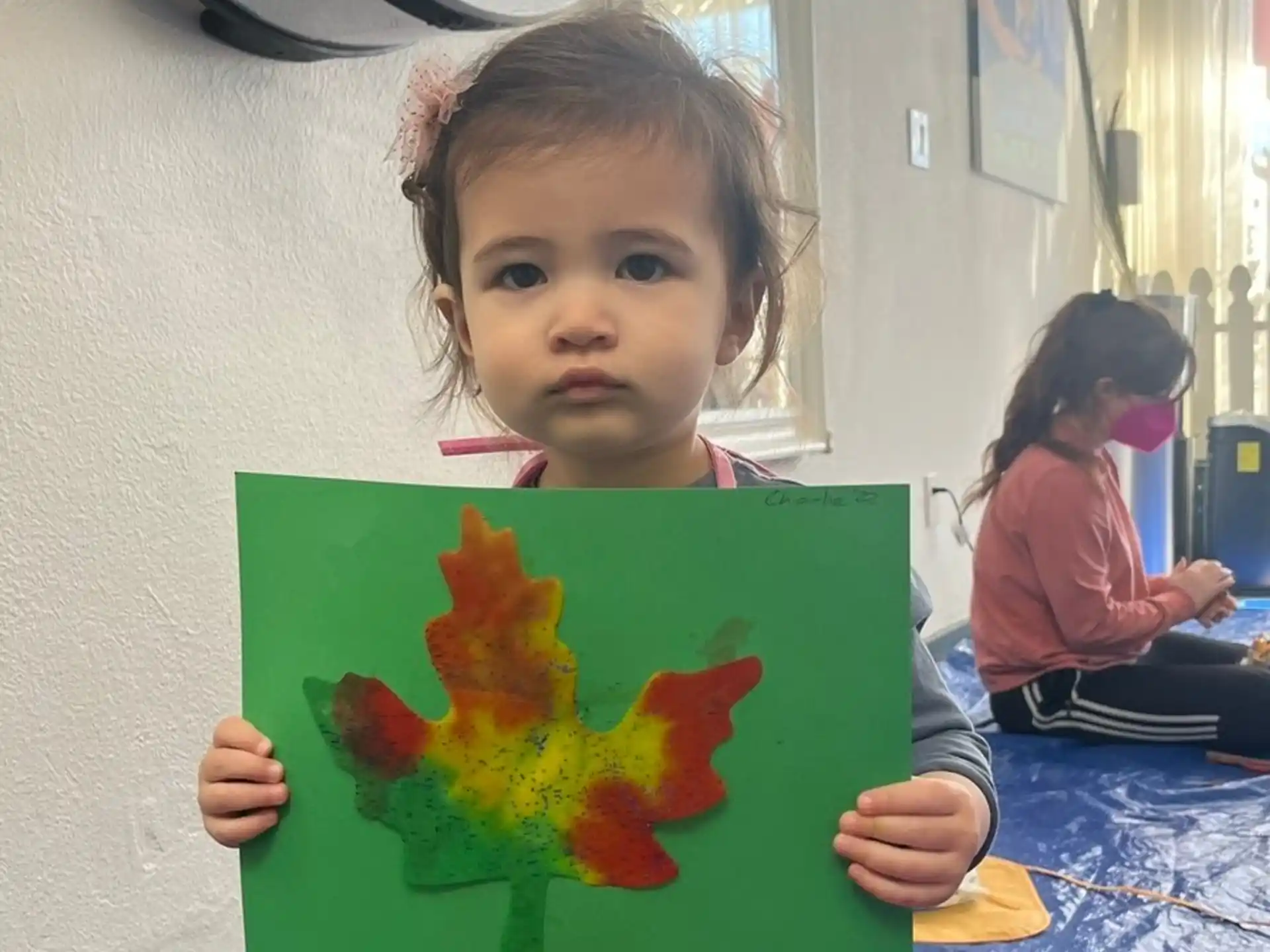 a young girl holding a book