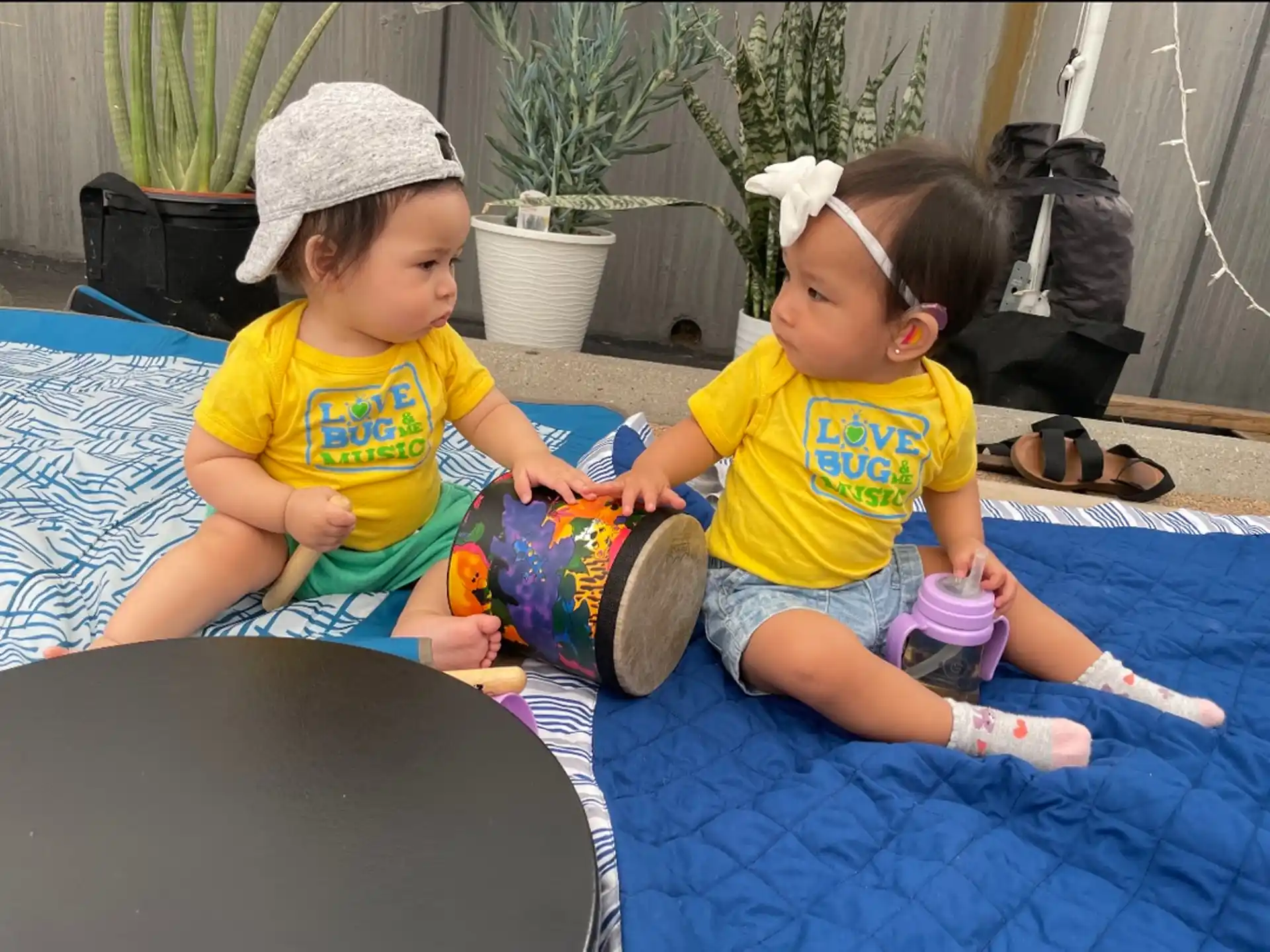 two children sitting on a mat