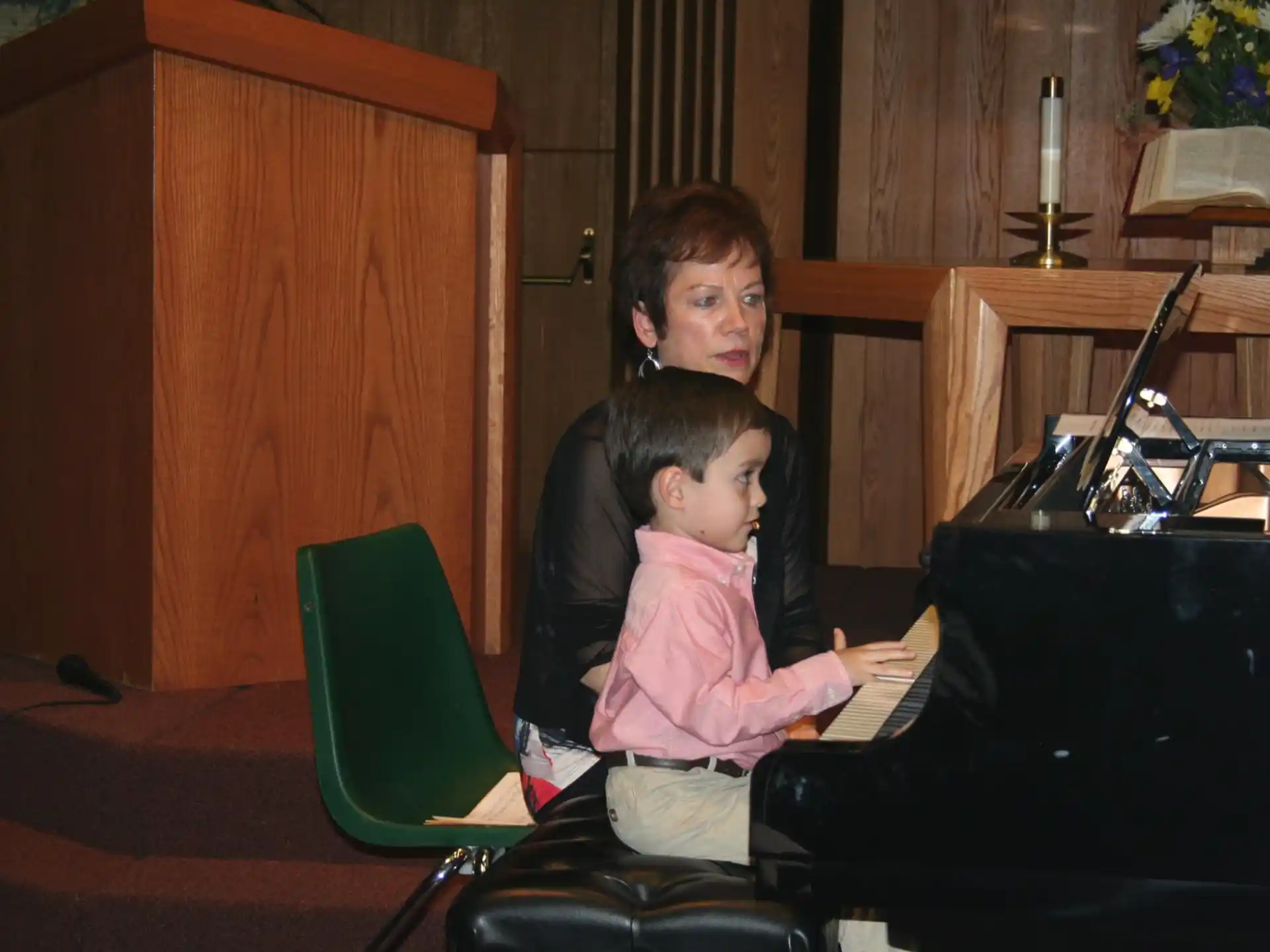 a person and a child playing piano
